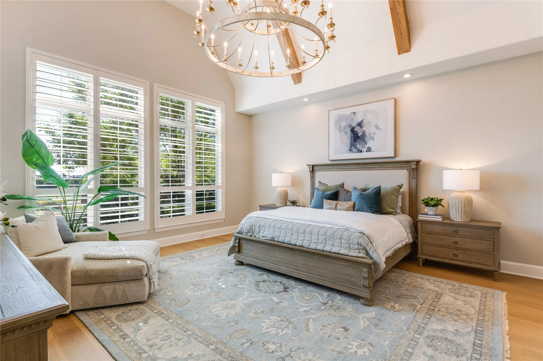 The impressive size of the primary bedroom presents a serene & luxurious retreat. Featuring another beamed, vaulted ceiling & blackout shades behind the plantation shutters.