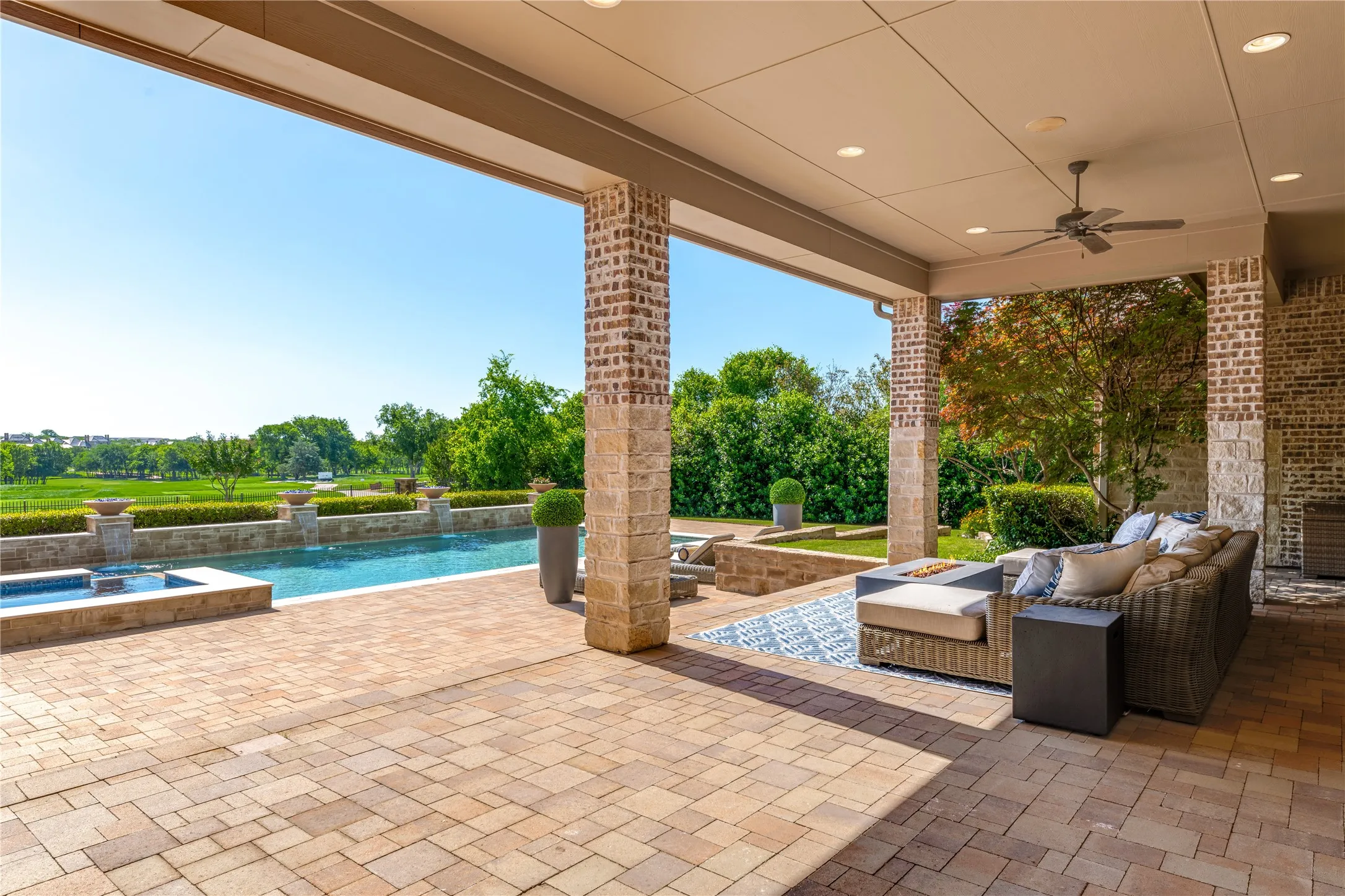 Comfortable outdoor seating offers a relaxing space perfectly positioned to capture views of golfers in the distance. One of four outdoor living spaces to choose from!