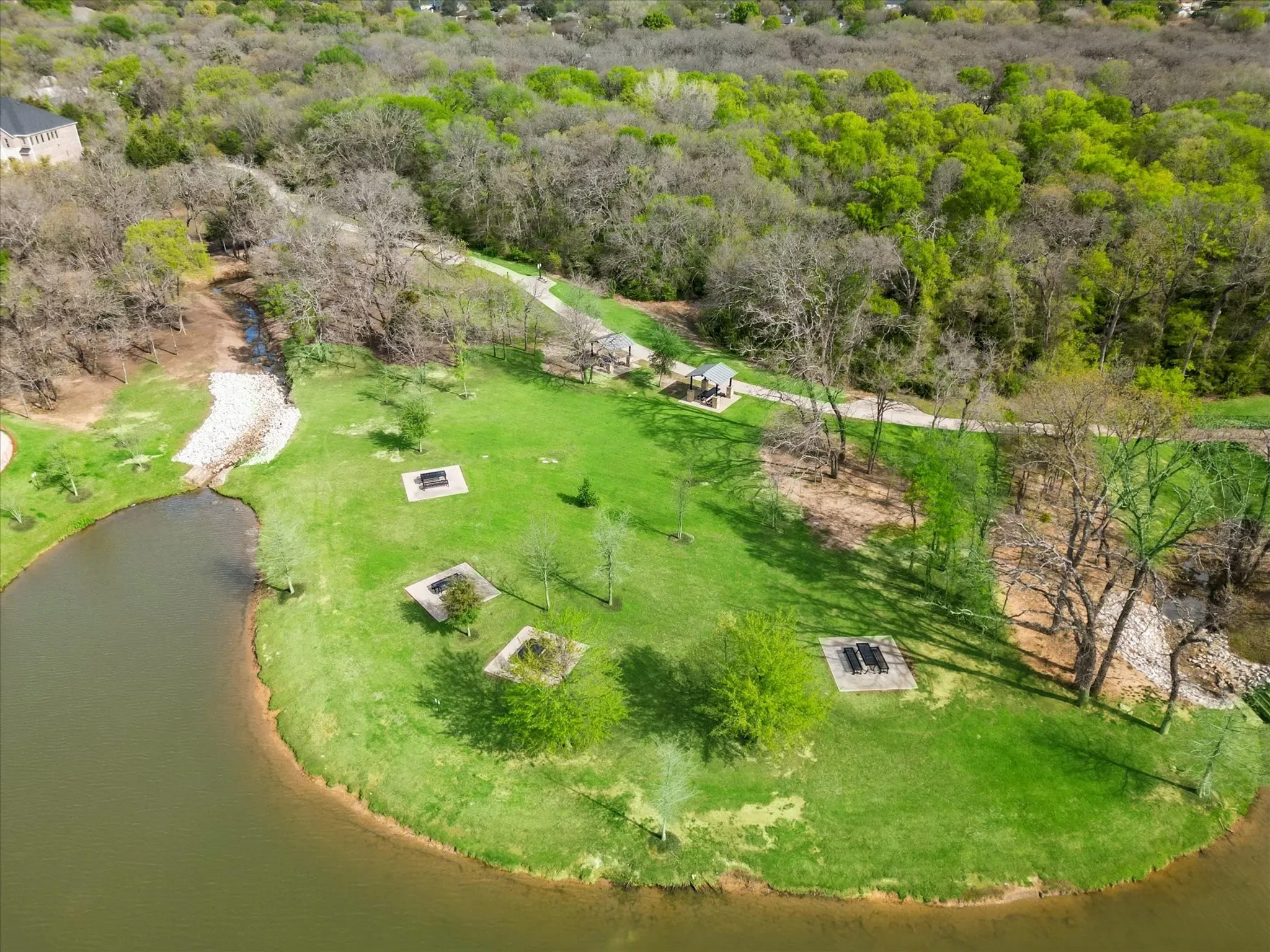 Drone / aerial view with a wooded view and a water view