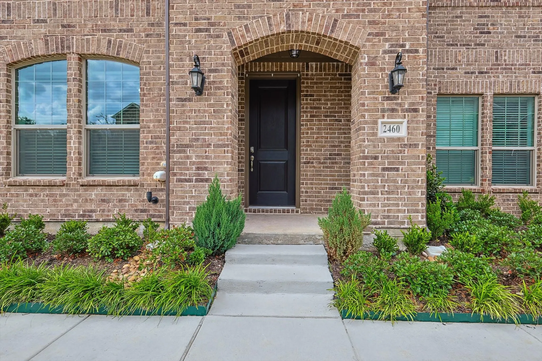 View of exterior entry with brick siding