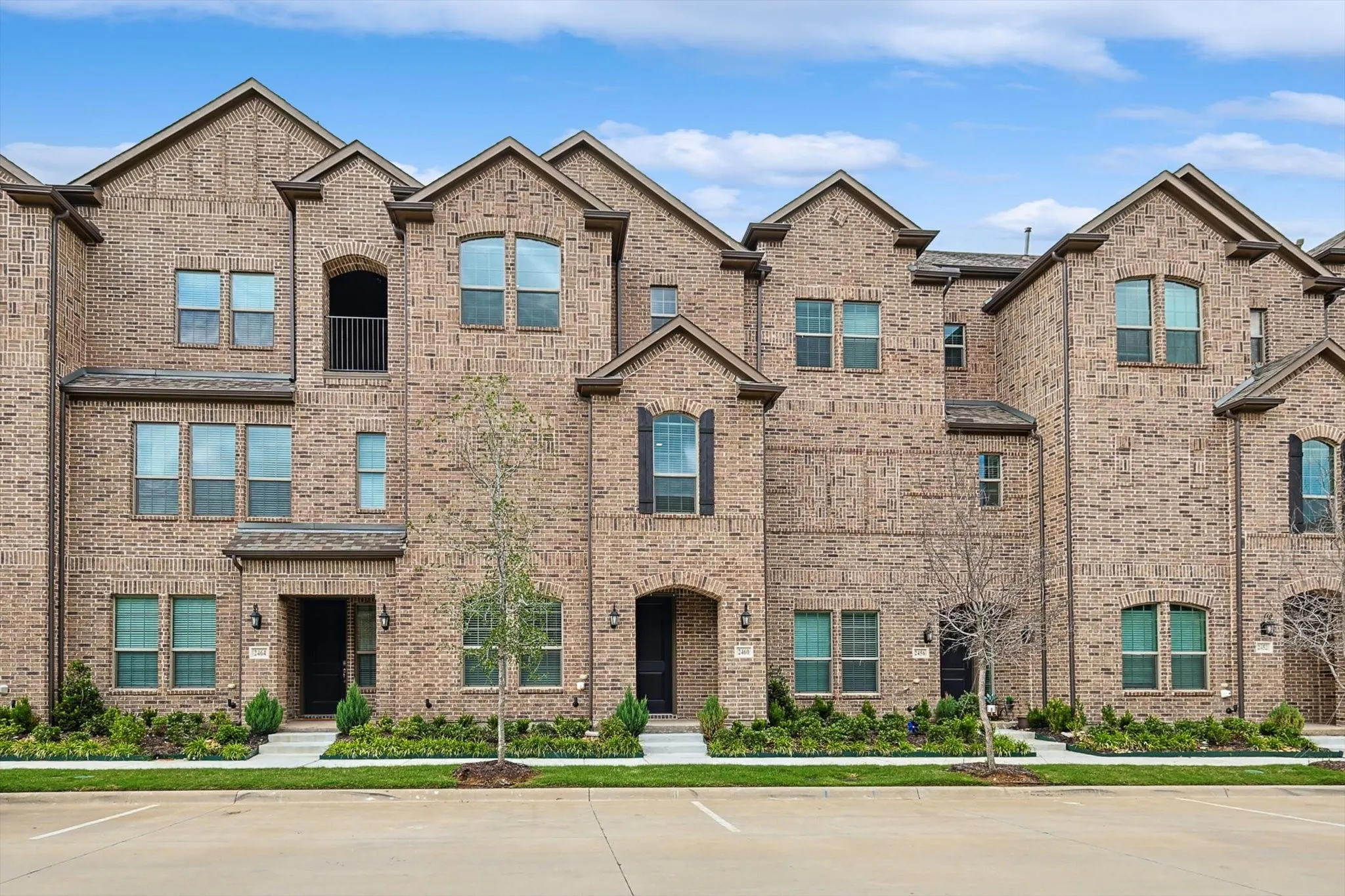 View of front of house featuring uncovered parking and brick siding