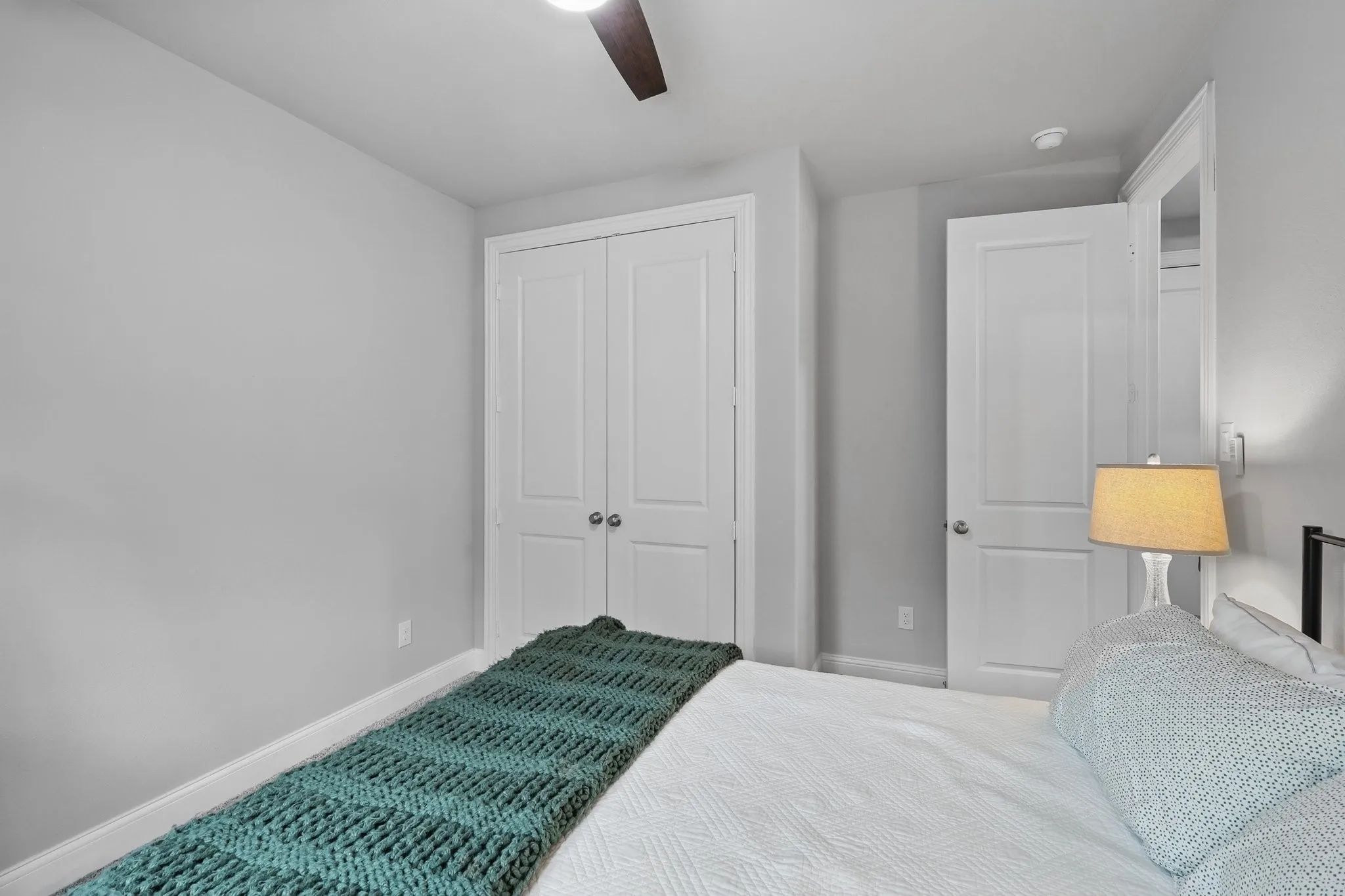 Bedroom featuring a closet, baseboards, and ceiling fan