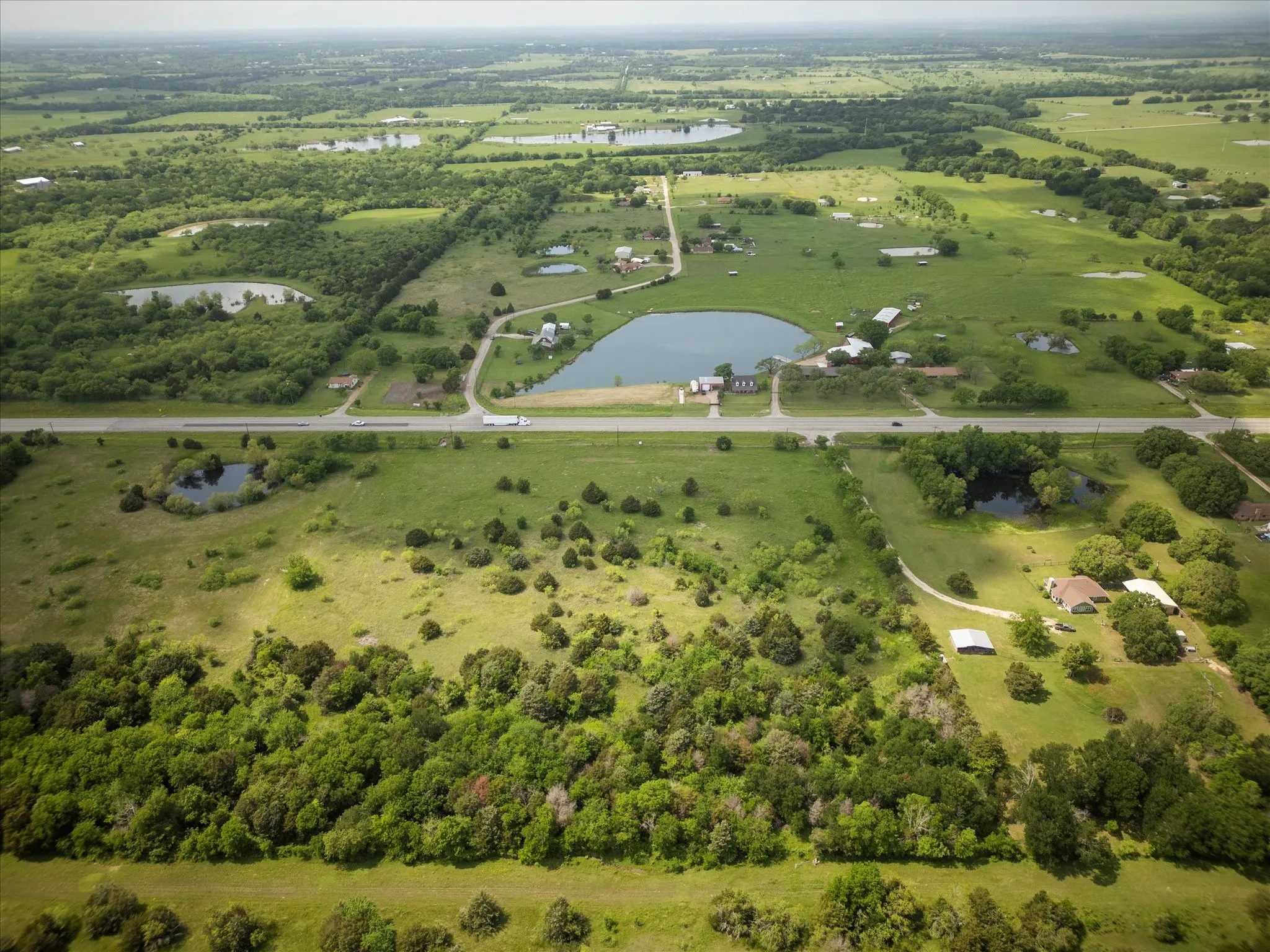 Aerial view with a water view and a rural view