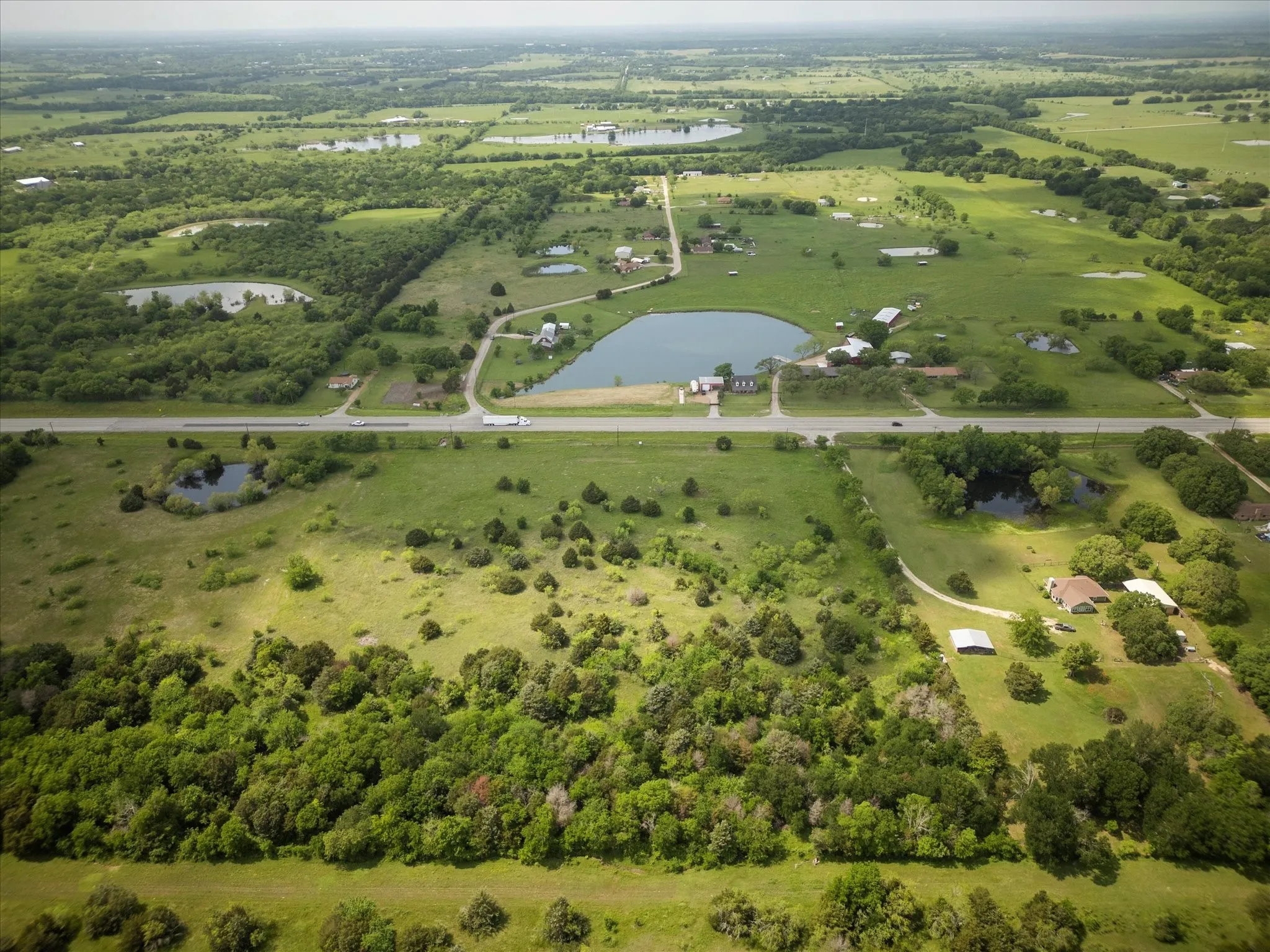 Aerial view with a water view and a rural view