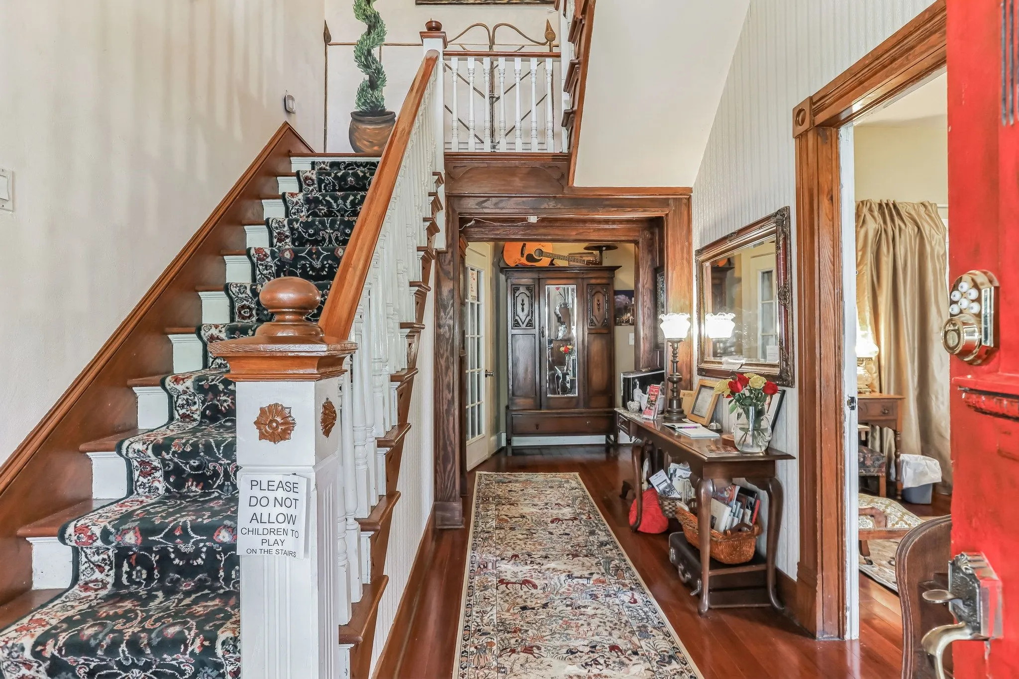Entrance foyer featuring dark wood-style flooring and stairs