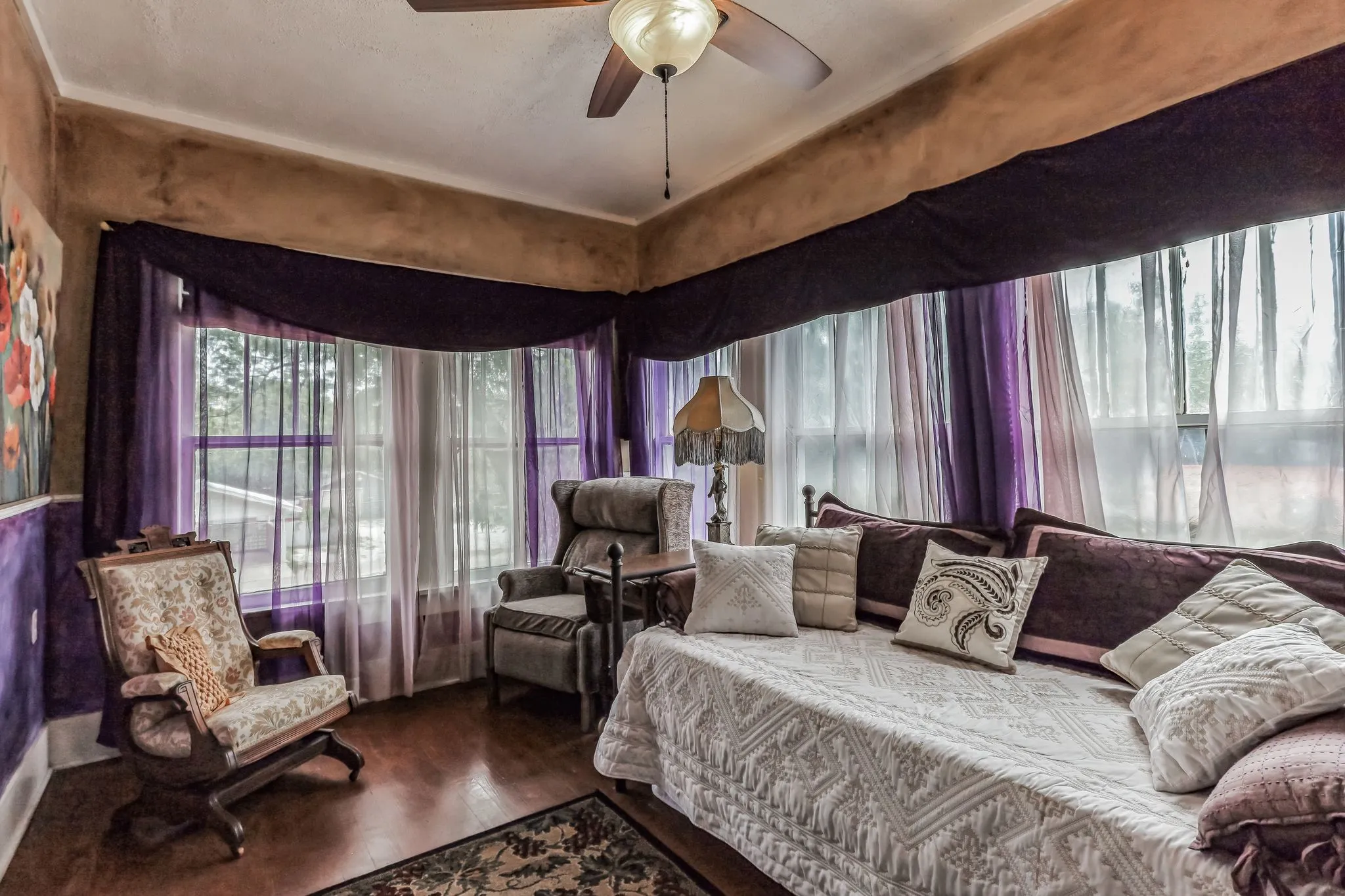 Bedroom featuring ceiling fan and wood finished floors