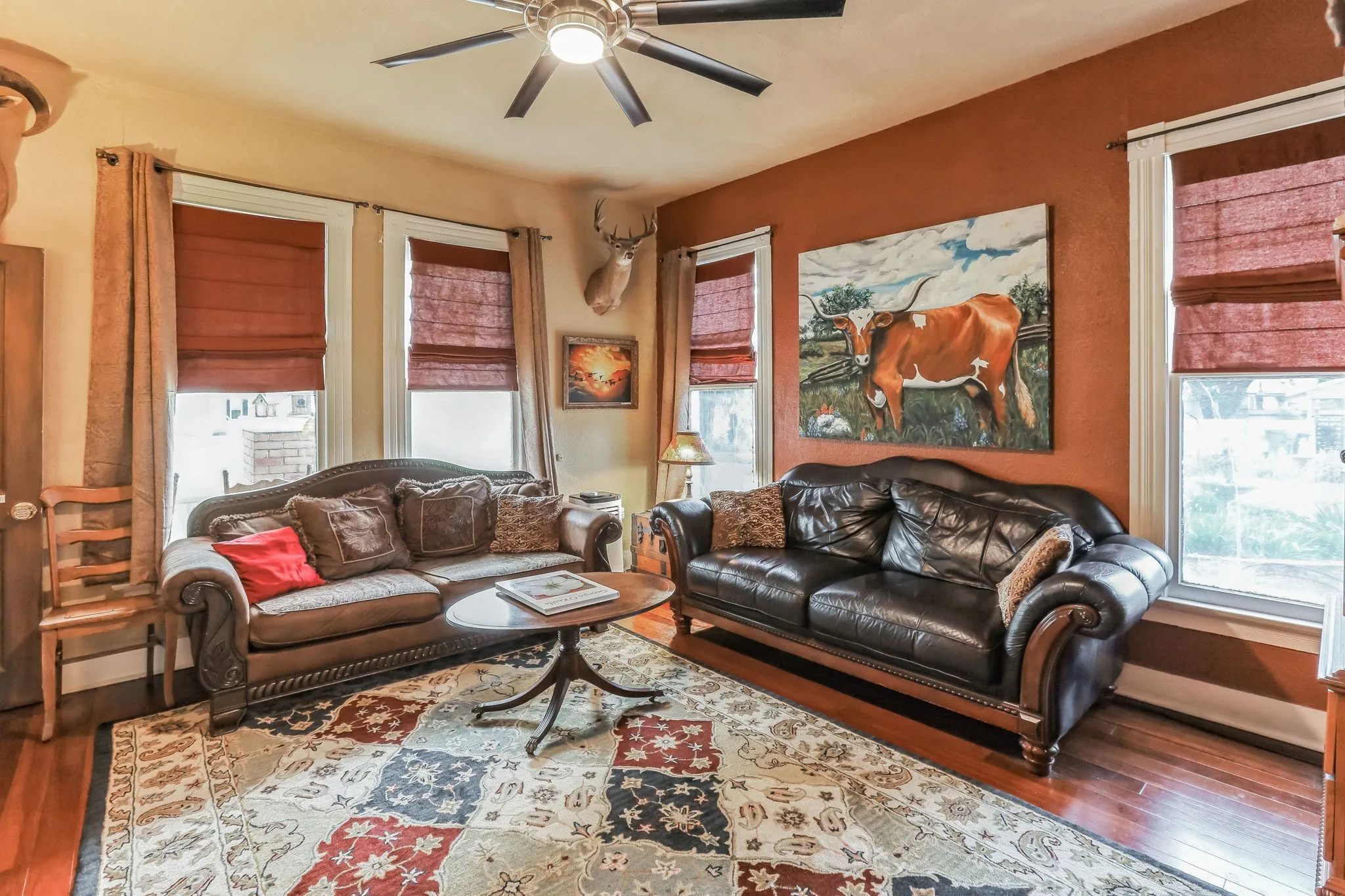 Living room featuring a ceiling fan and wood finished floors