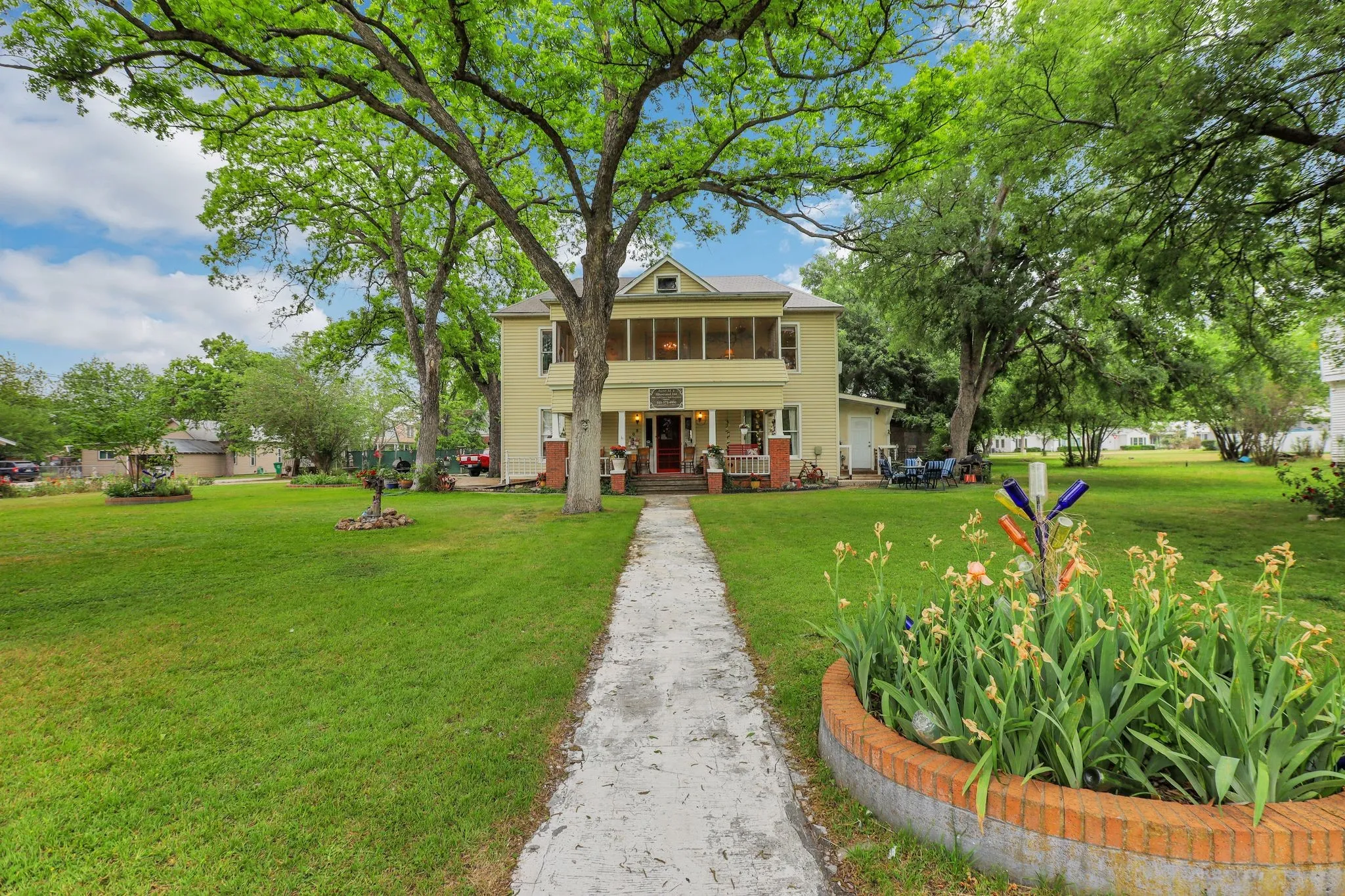 View of front of property with a front yard and a sunroom
