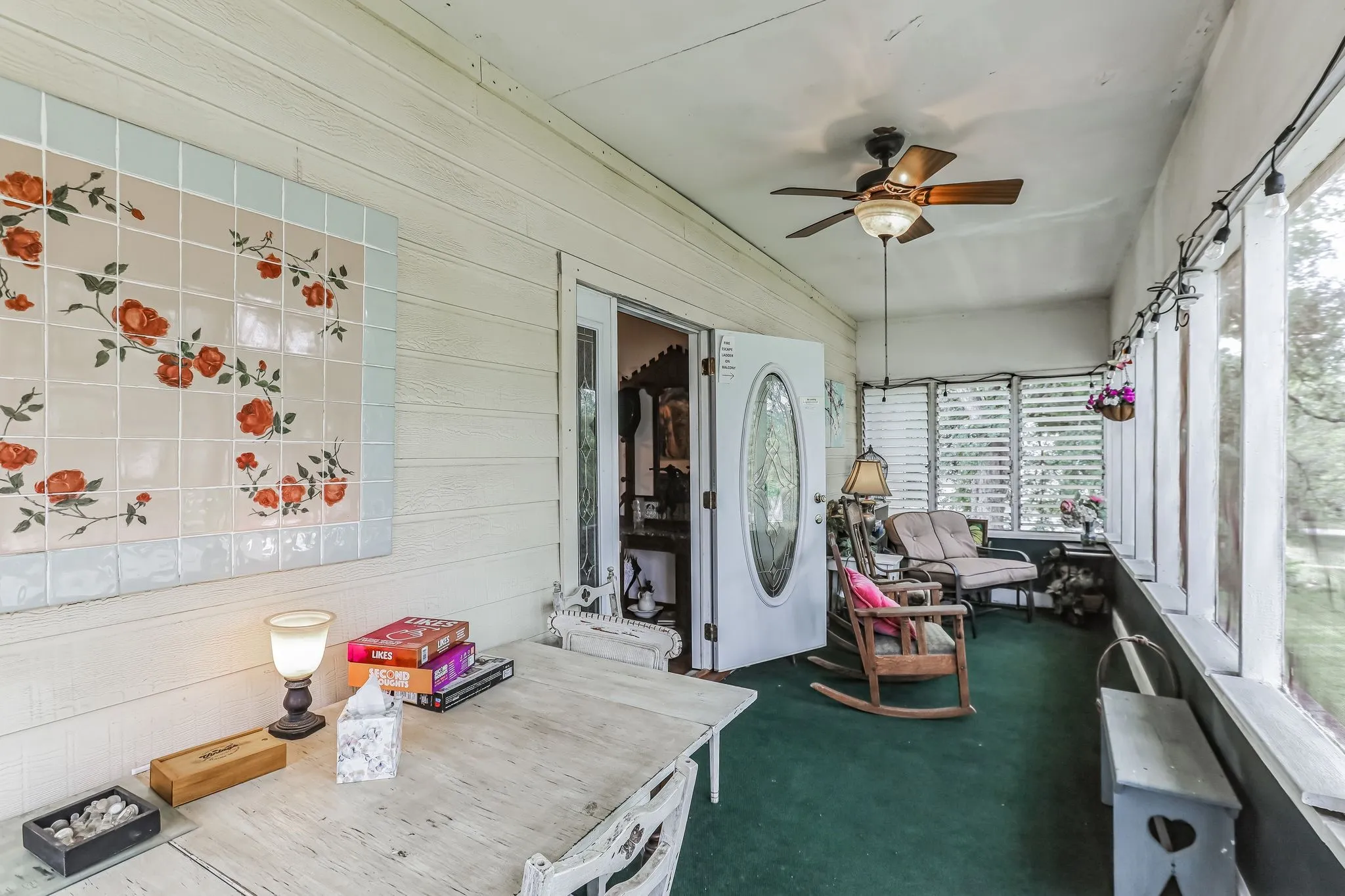 Unfurnished sunroom with wooden walls, a wealth of natural light, and carpet flooring