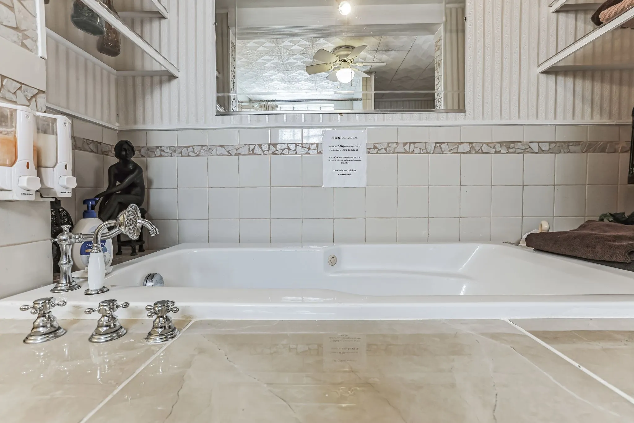 Full bathroom featuring a tub to relax in and ceiling fan