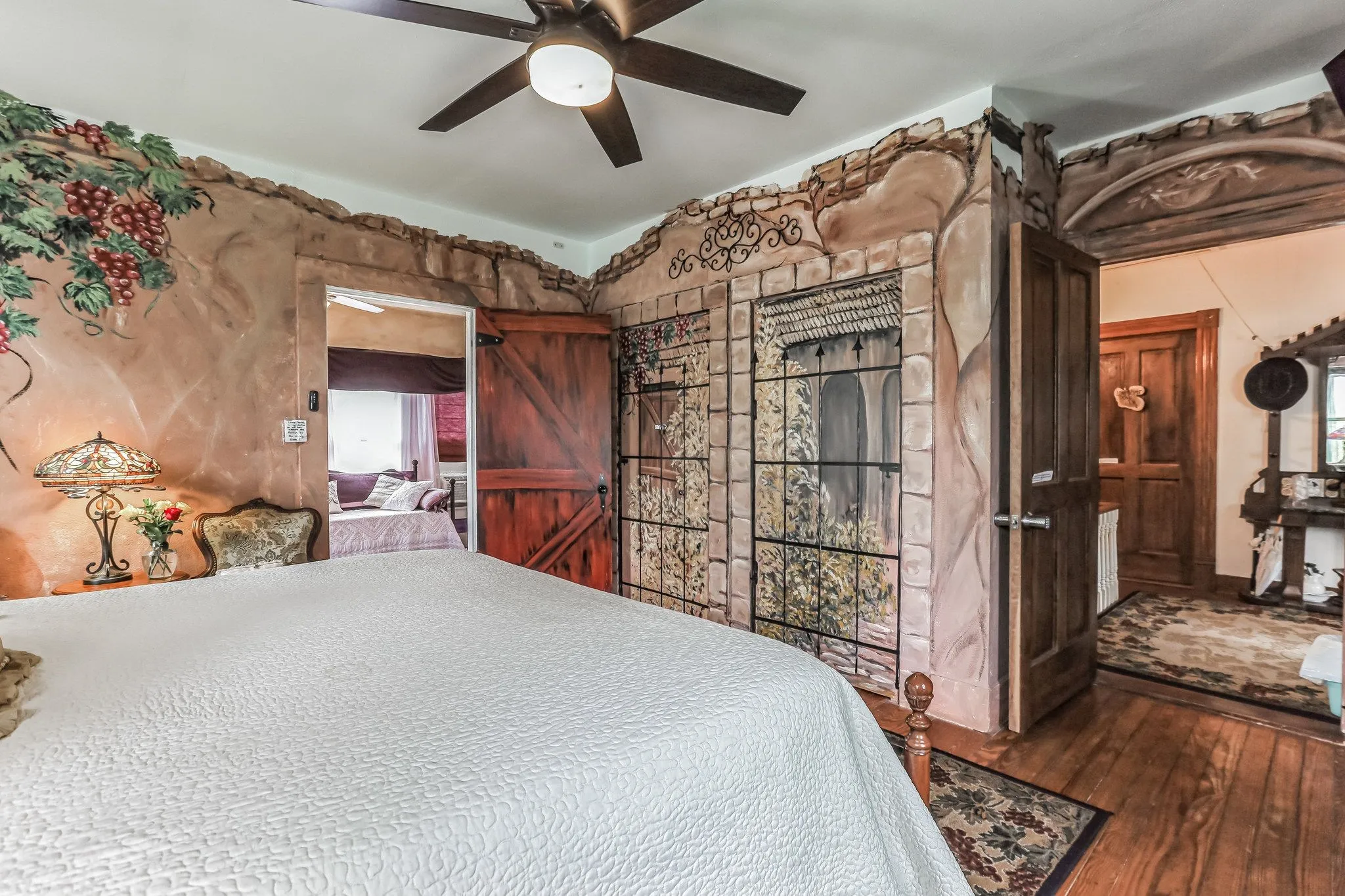 Bedroom featuring ceiling fan and hardwood / wood-style flooring