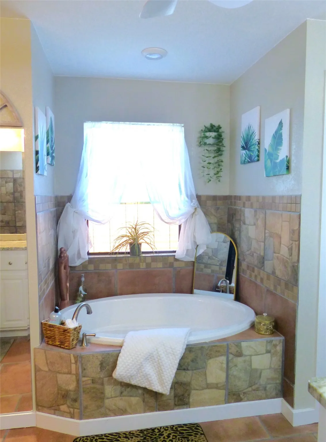 Bathroom with a bath, vanity, and light tile patterned floors