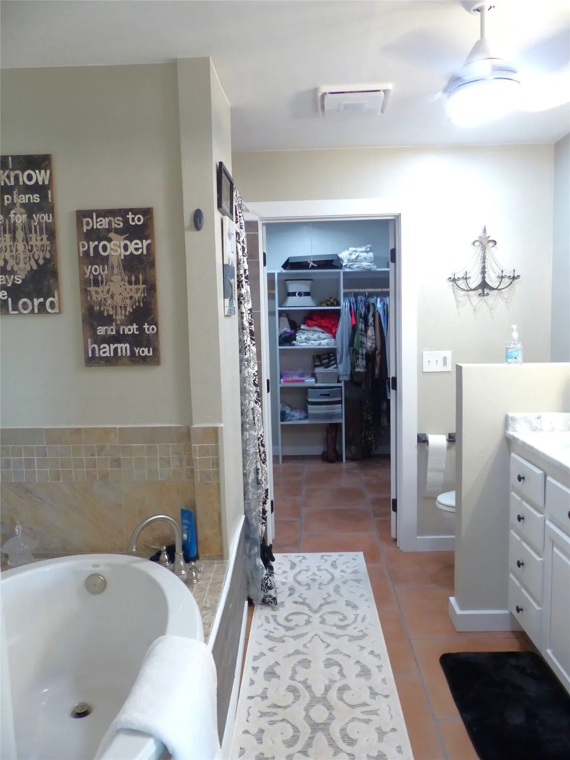 Bathroom featuring a bath, visible vents, tile patterned floors, vanity, and toilet
