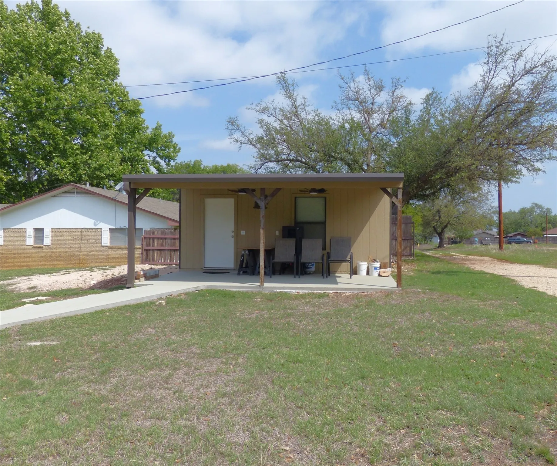 View of front of house featuring fence and a front lawn