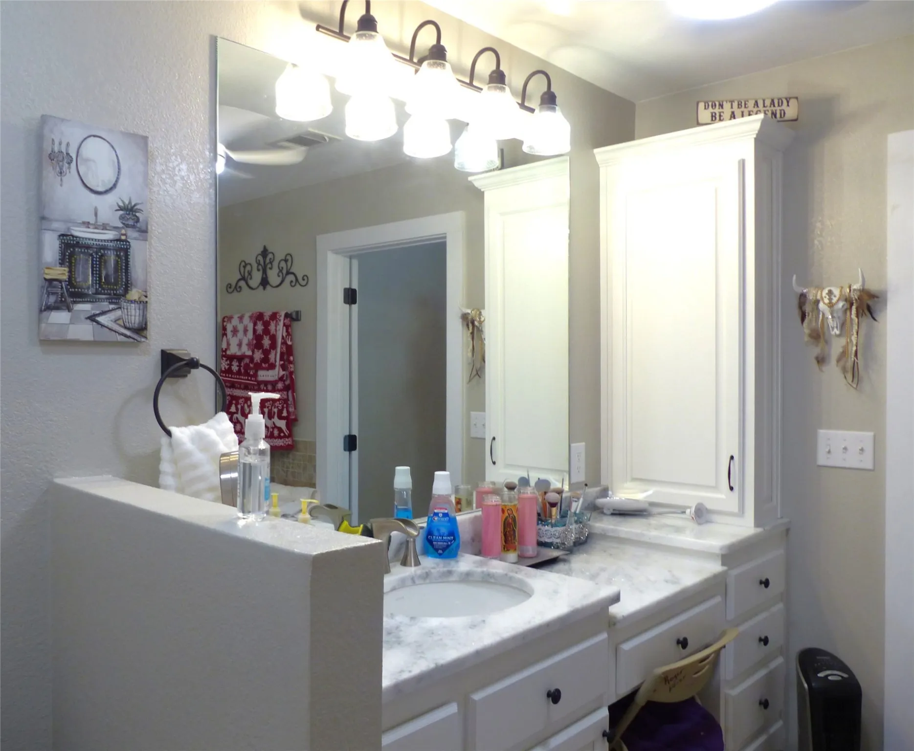 Bathroom with vanity and a textured wall
