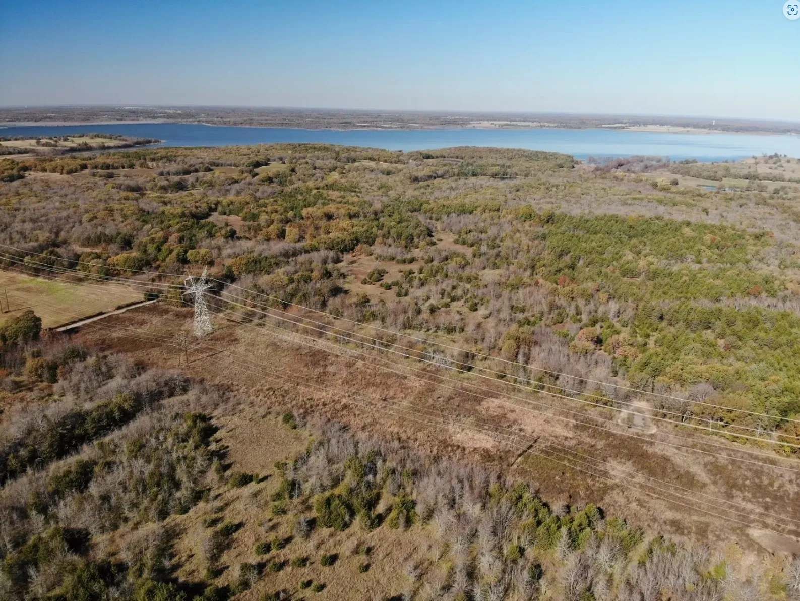 Bird's eye view with a water view and a forest view