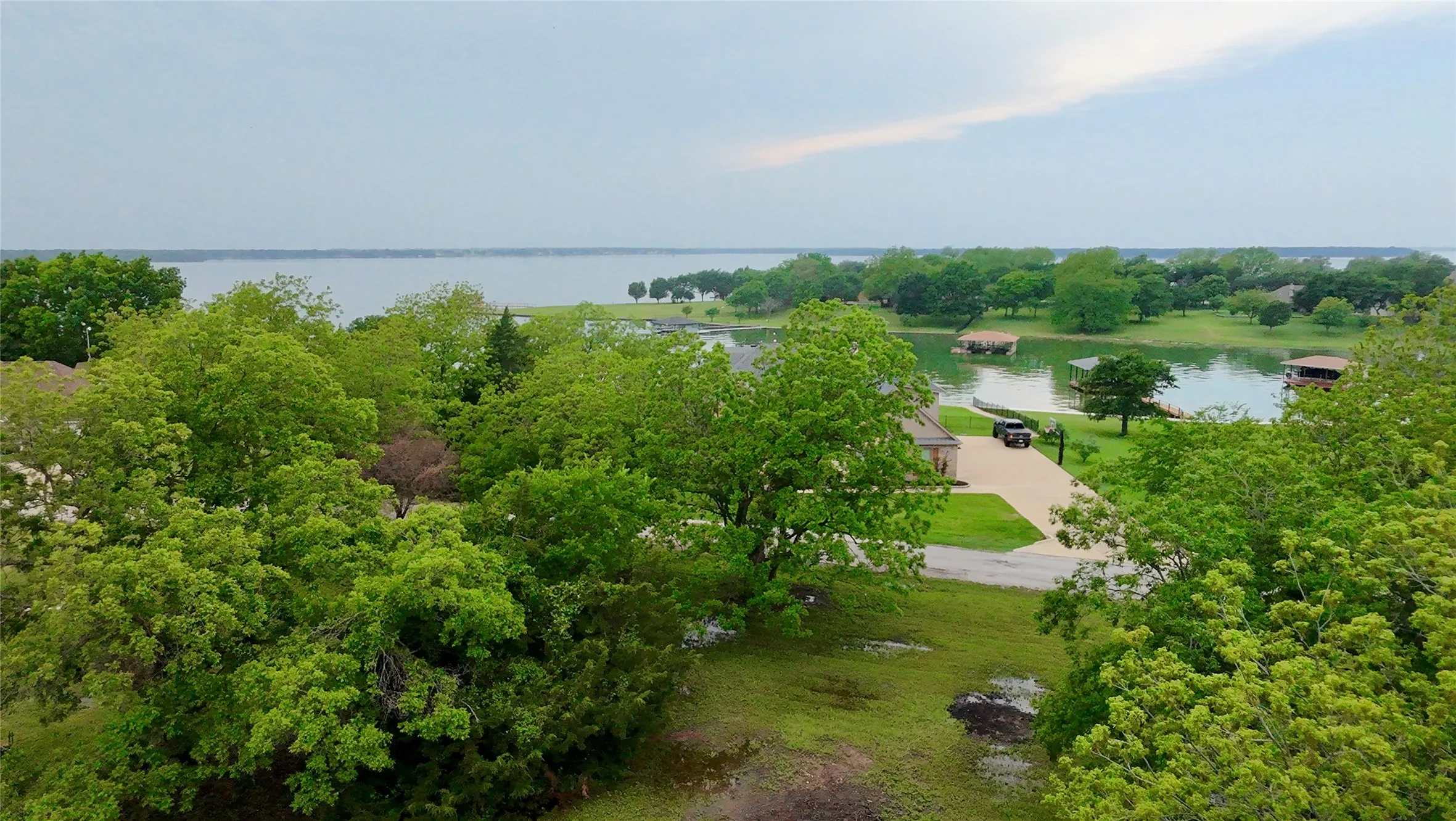 Birds eye view of property with a water view