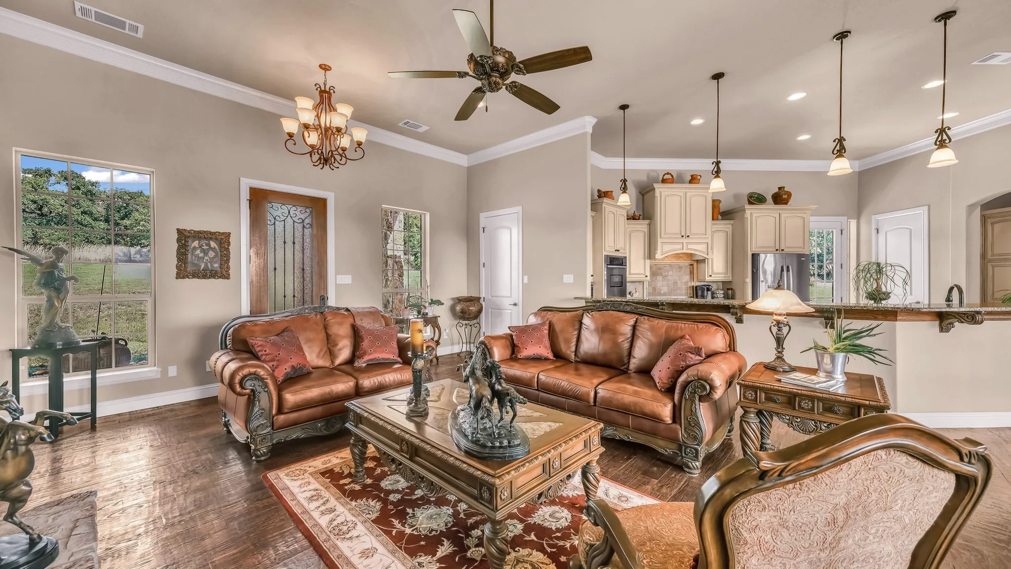 Living area with baseboards, visible vents, and plenty of natural light