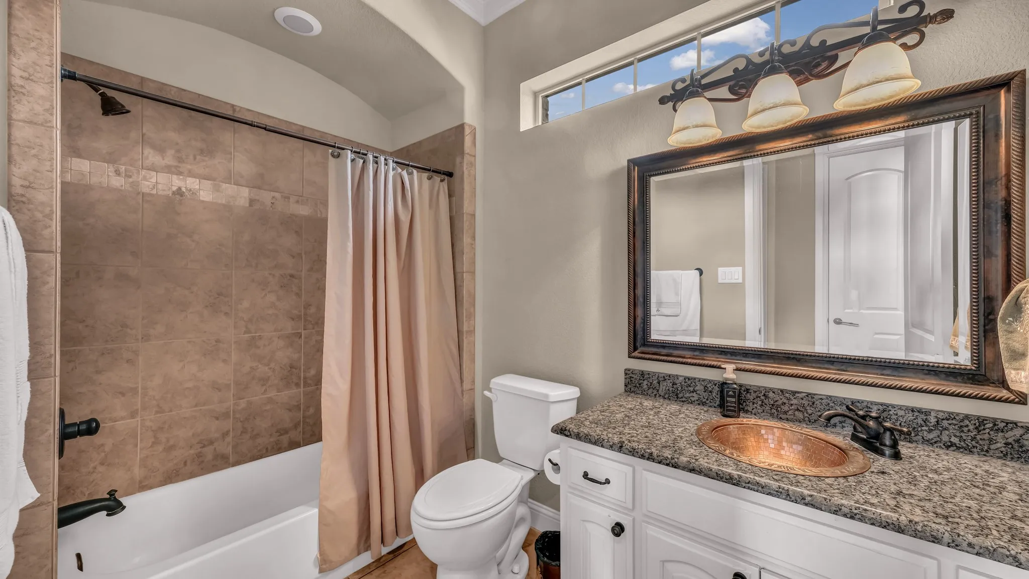 Full bathroom with vanity, shower / bathtub combination with curtain, and toilet