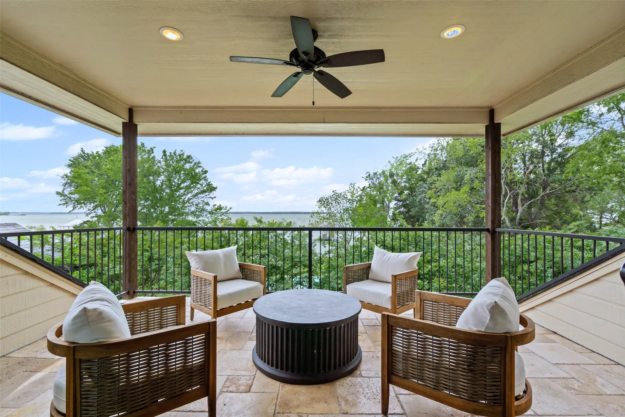 Just off the game room, a covered balcony offers sweeping views of the lake and sky, the perfect spot to relax and unwind.