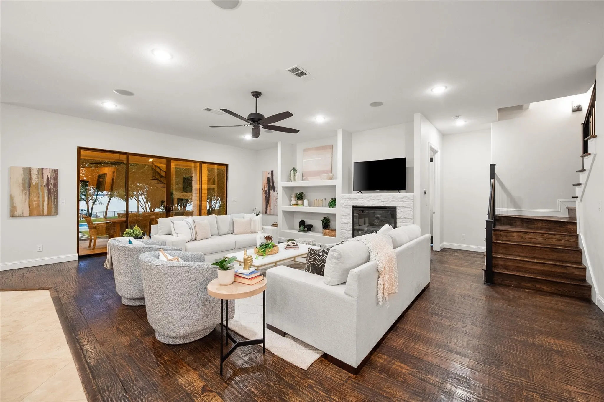 Expansive sliding glass doors frame the waterfront view and open to a large patio for seamless indoor-outdoor living.
