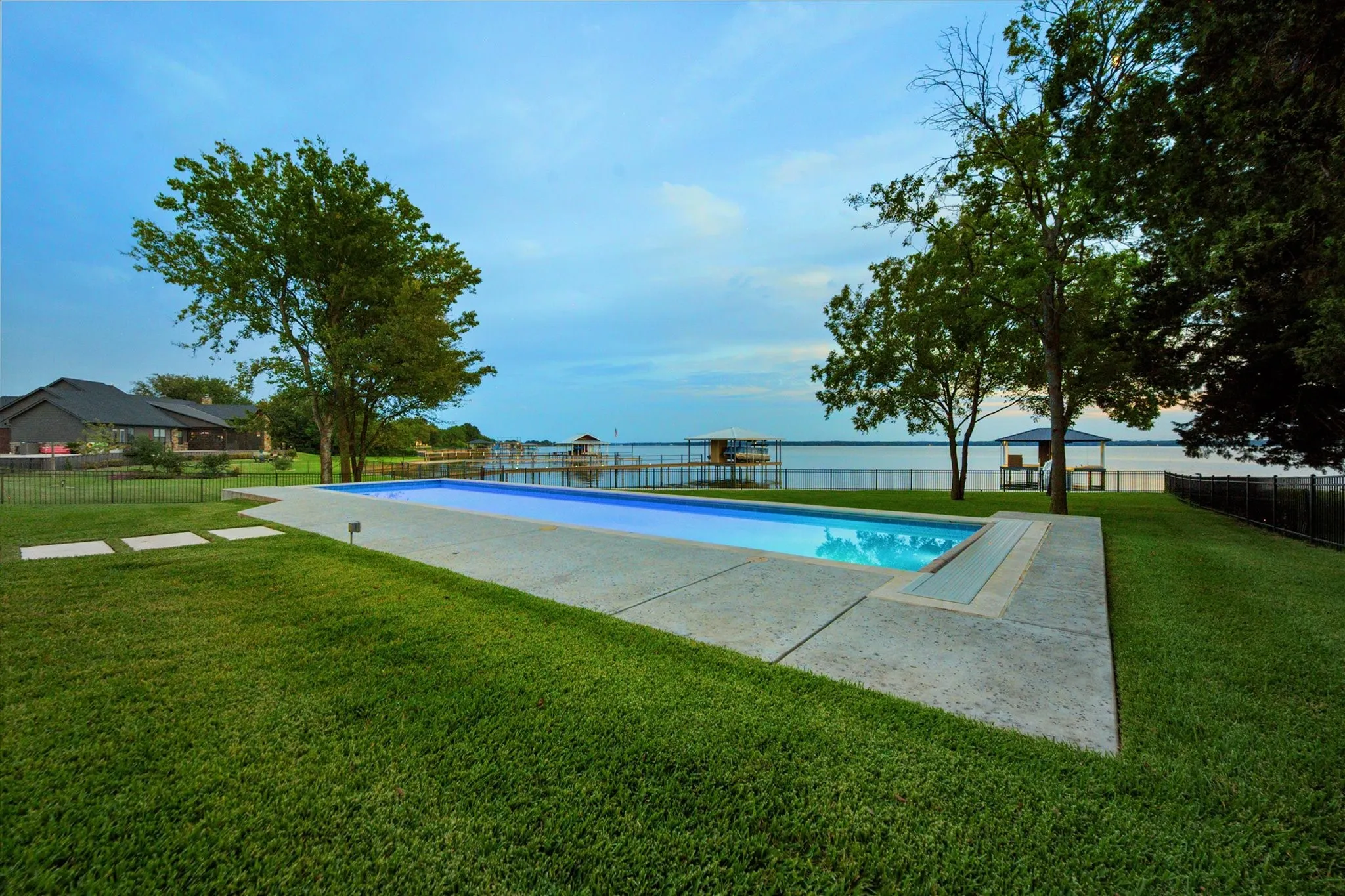 A 60-foot pool with lake views creates the ultimate backdrop for swimming, lounging, and entertaining. The pool includes a heating-cooling pump and an automatic cover.