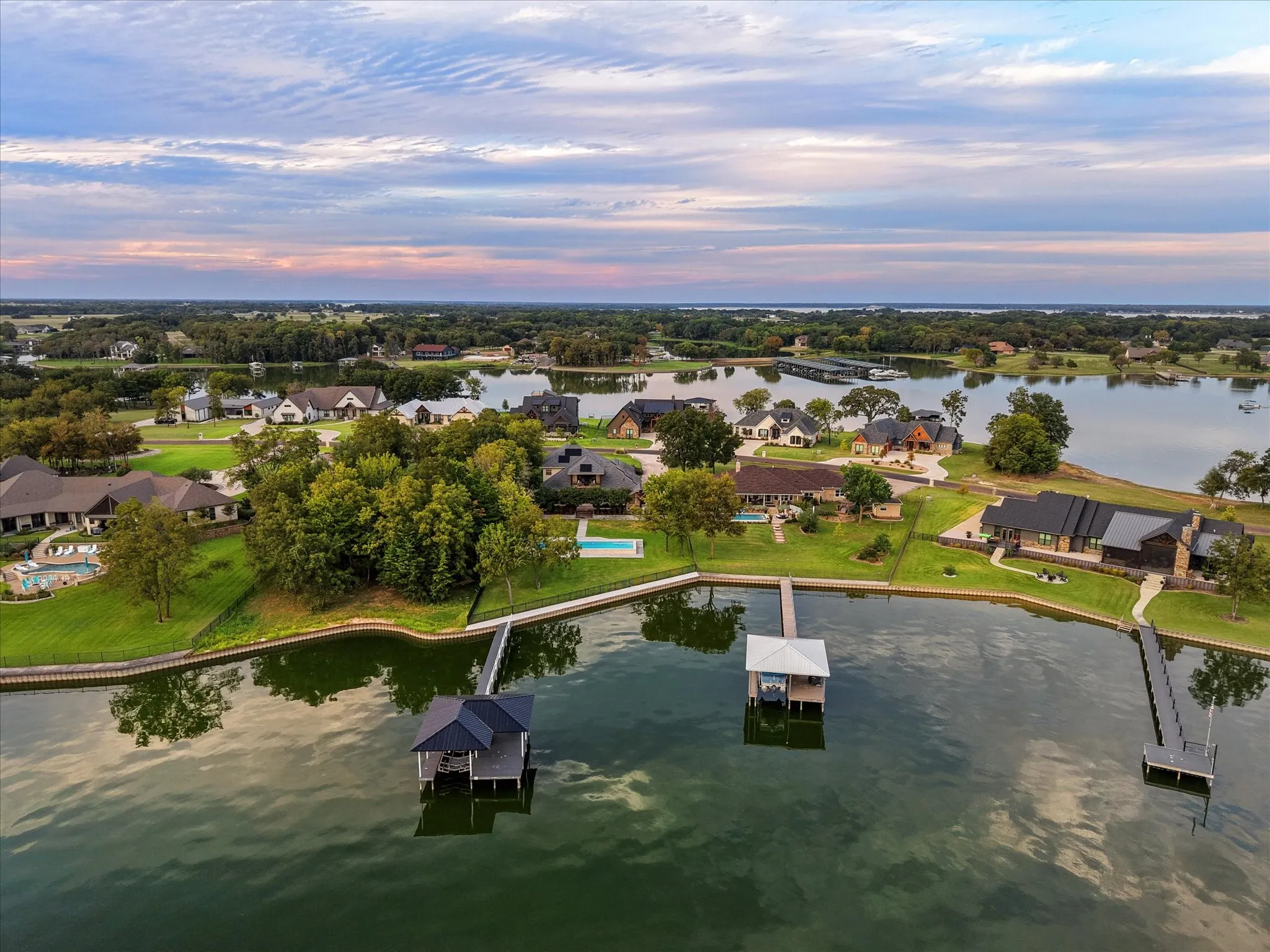 An aerial view captures the harmony of the boathouse, lake, pool, and home in one sweeping scene, nestled along one of Richland Chambers Lake’s most desirable stretches.