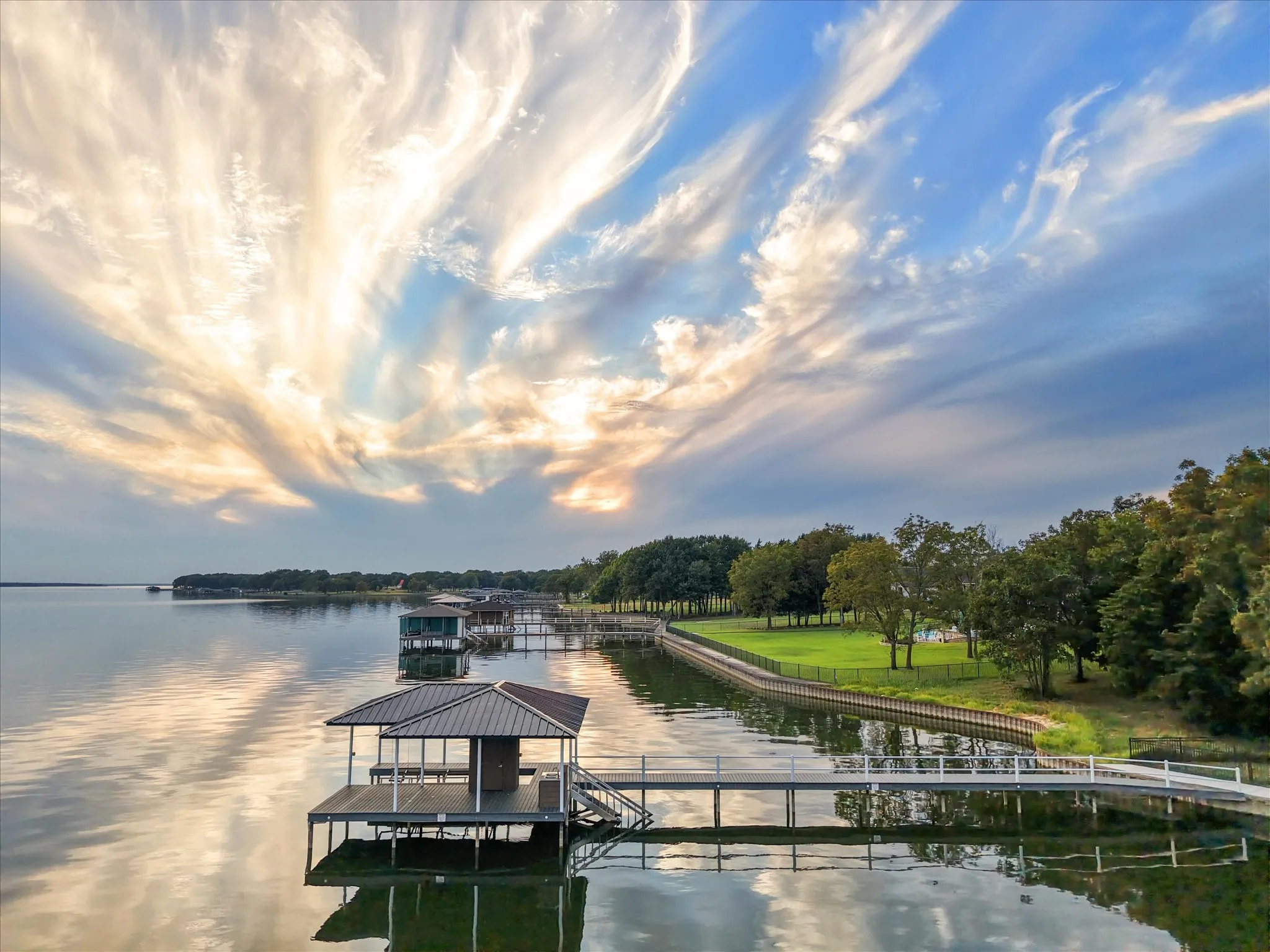Evenings often bring dramatic skies over the boathouse, where you can fish, swim, or simply take in the view.