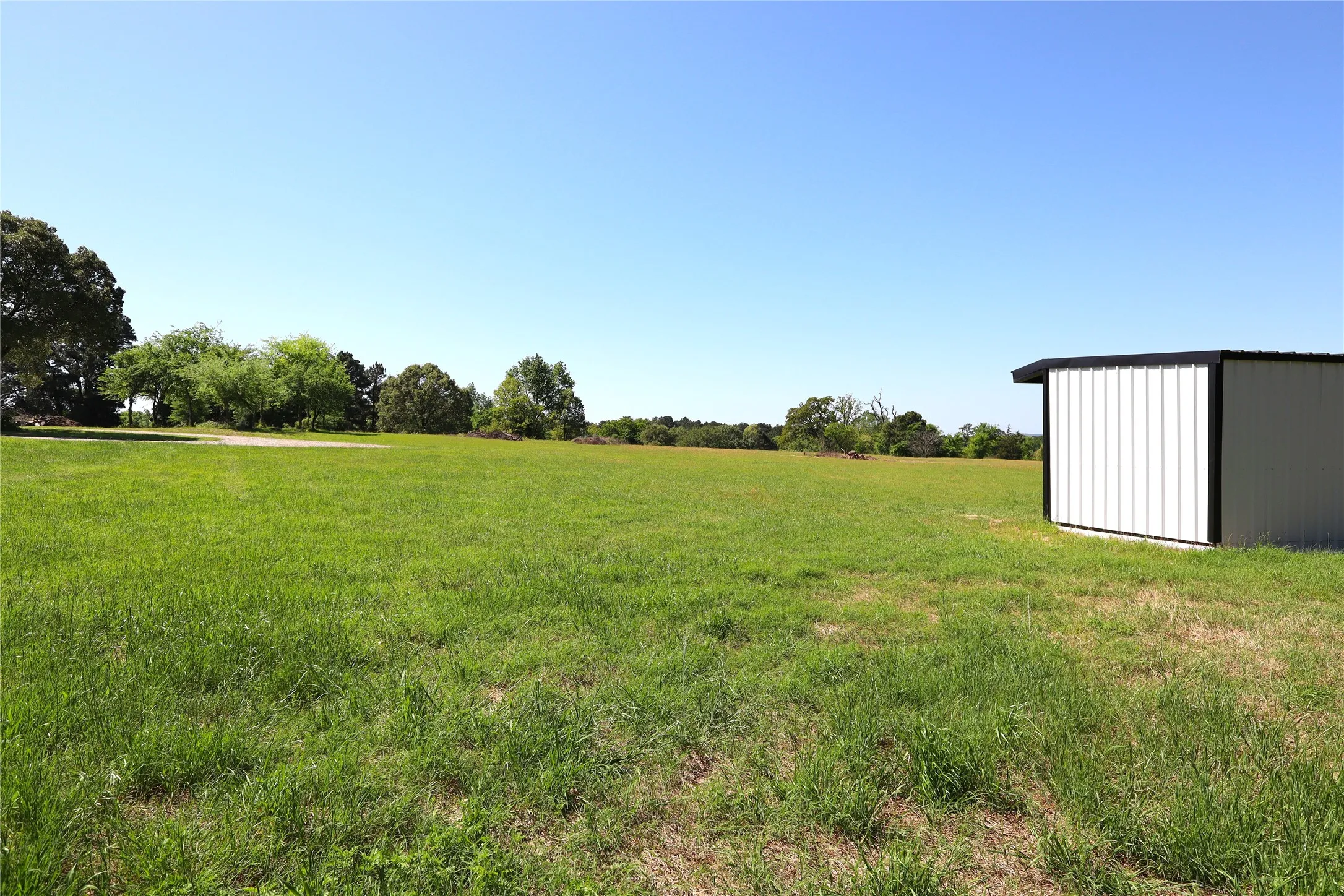 View of yard featuring a rural view and an outbuilding