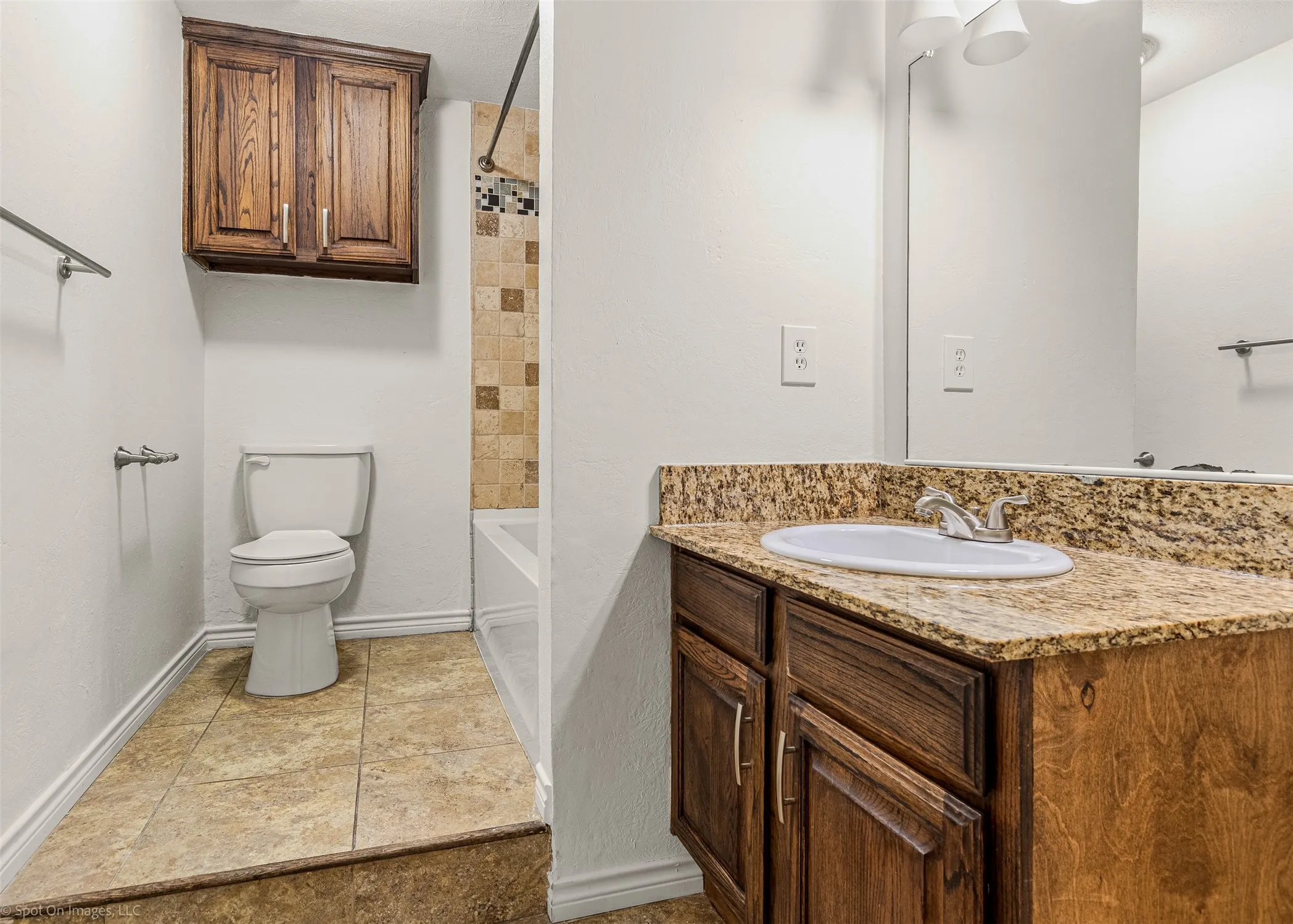 Bathroom with toilet, shower / bathtub combination, baseboards, and vanity