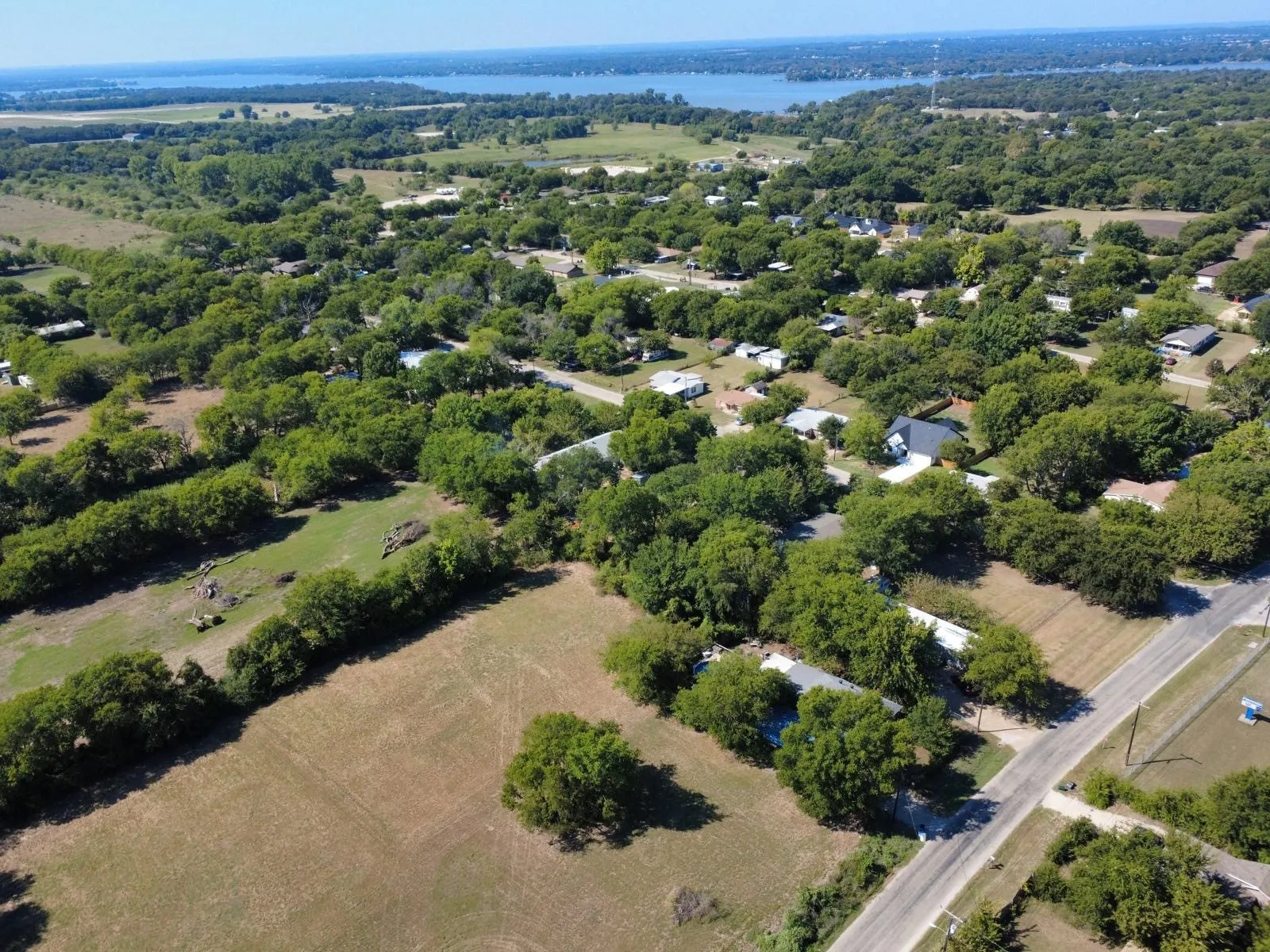 Aerial view of property and surrounding area featuring a large body of water
