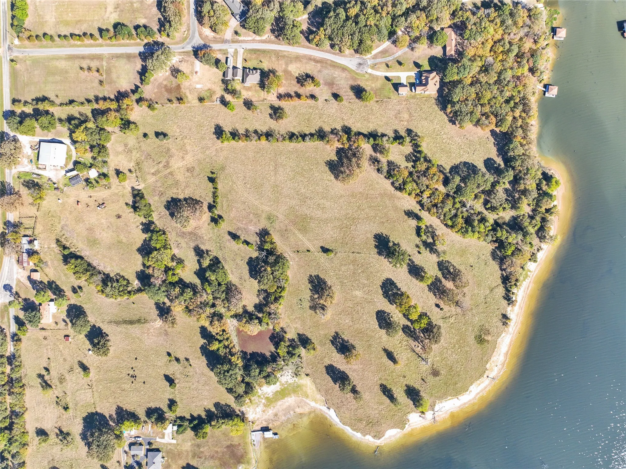 Aerial overview of property's location with a large body of water and rural landscape