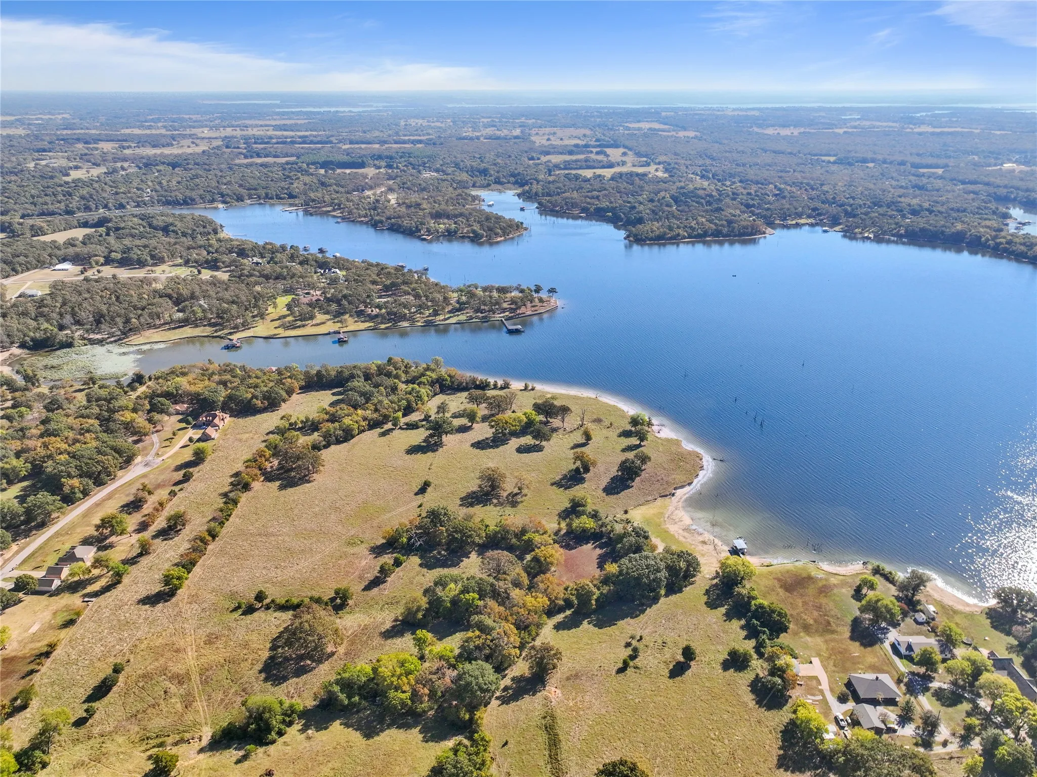 Aerial view of a nearby body of water and a heavily wooded area