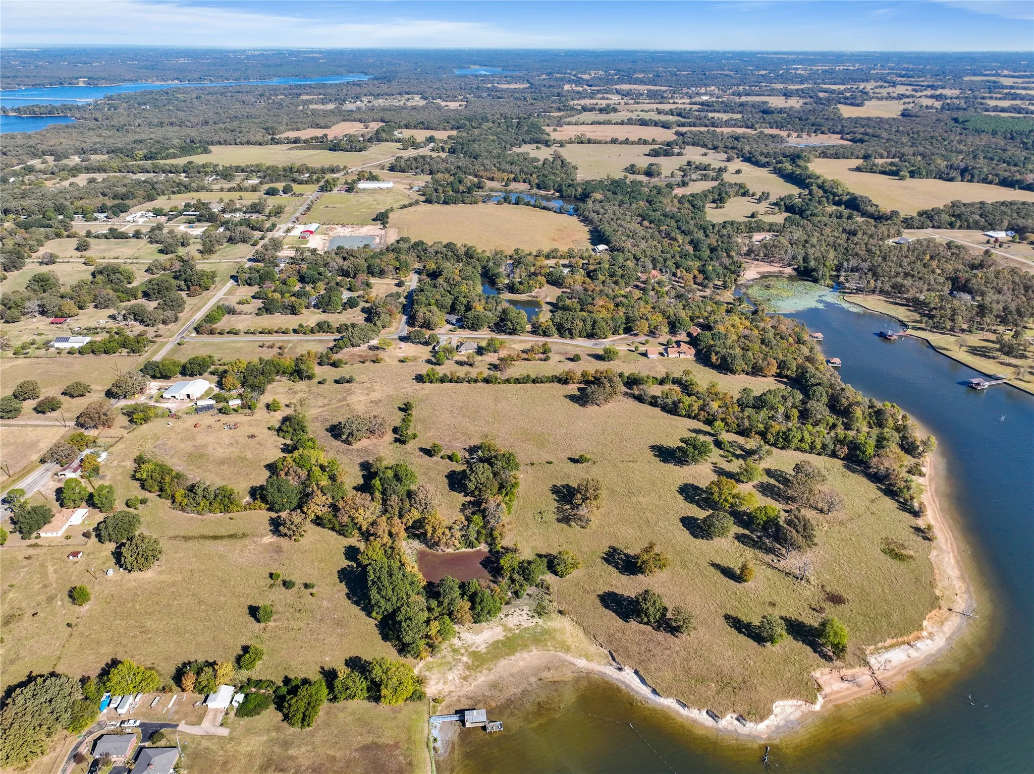 Aerial view of property's location with a large body of water