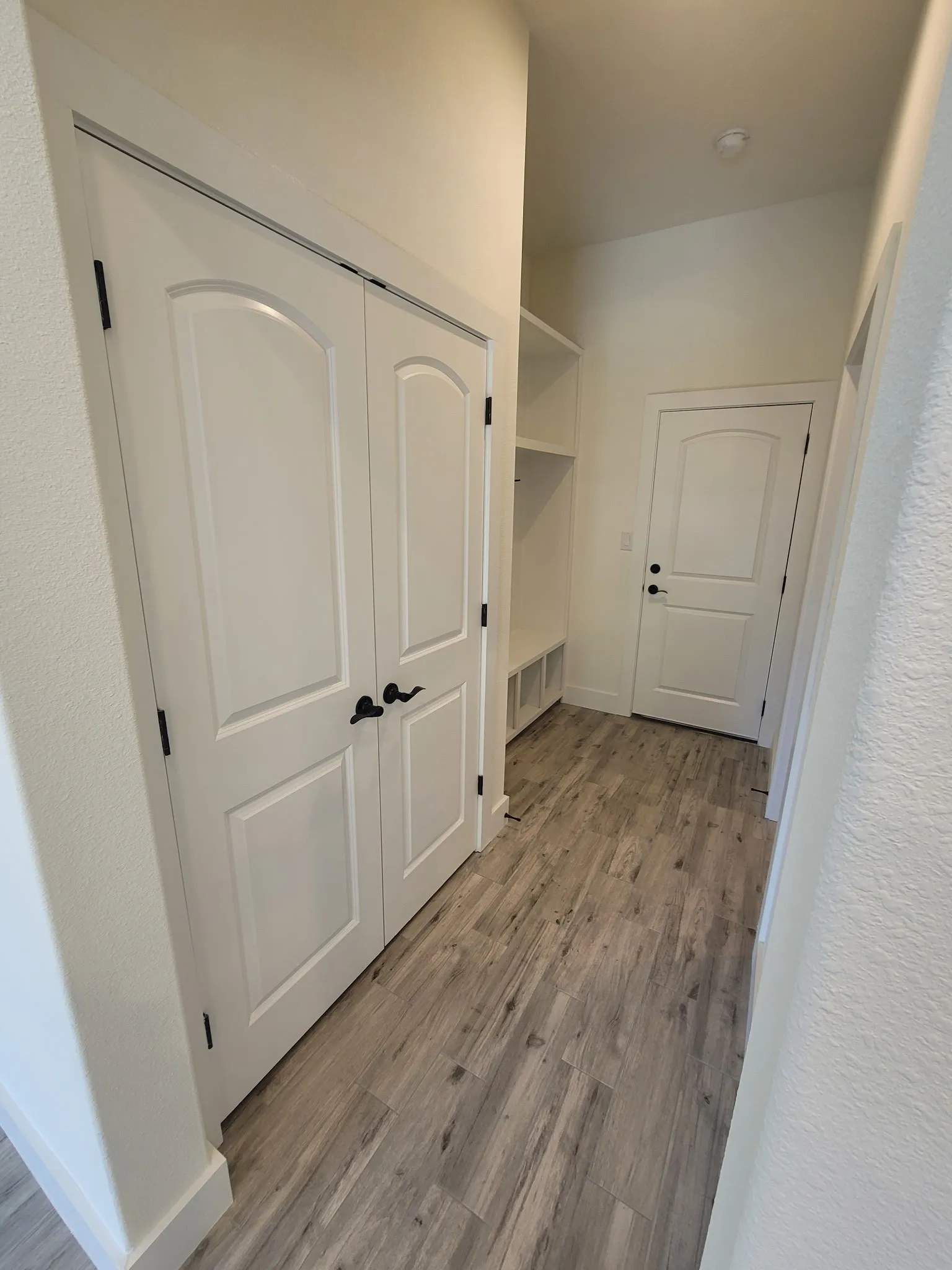 Hall with light wood finished floors and baseboards