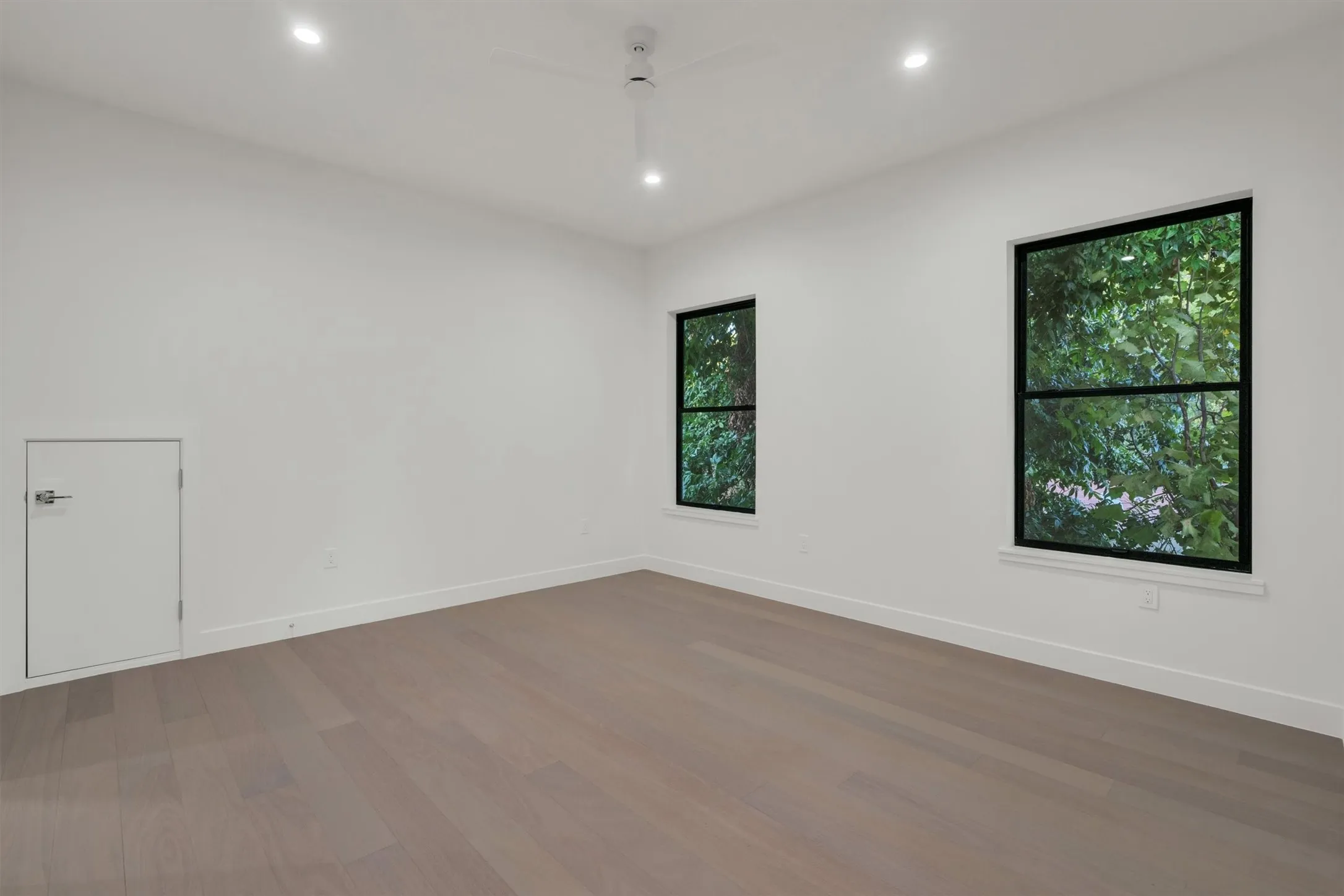 Unfurnished room with wood finished floors, recessed lighting, and baseboards