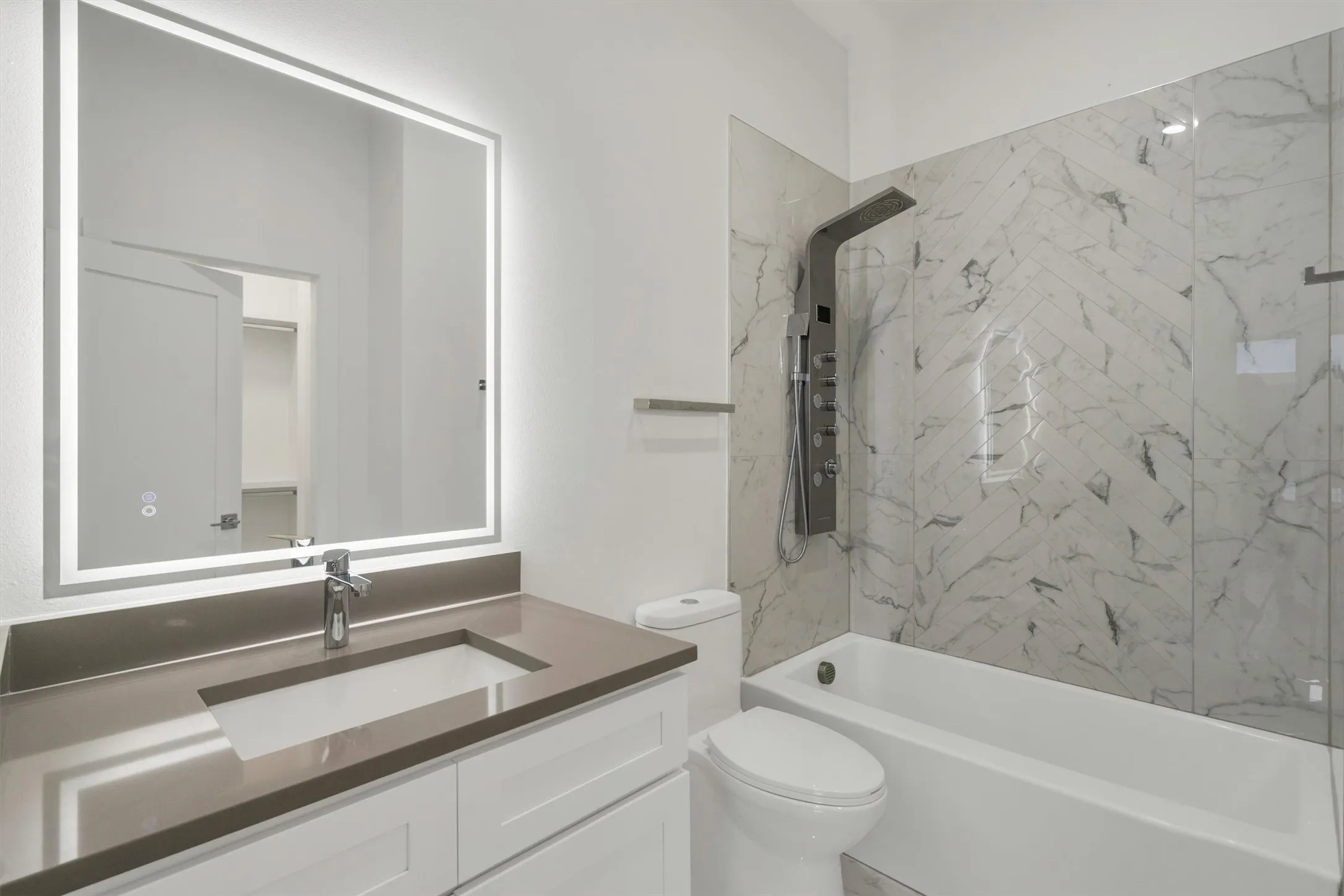 Full bathroom with toilet, vanity, and bathing tub / shower combination