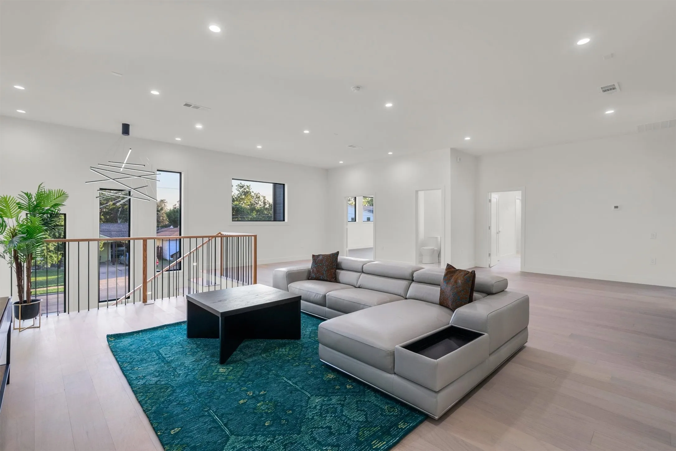 Living room with light wood-style floors and recessed lighting