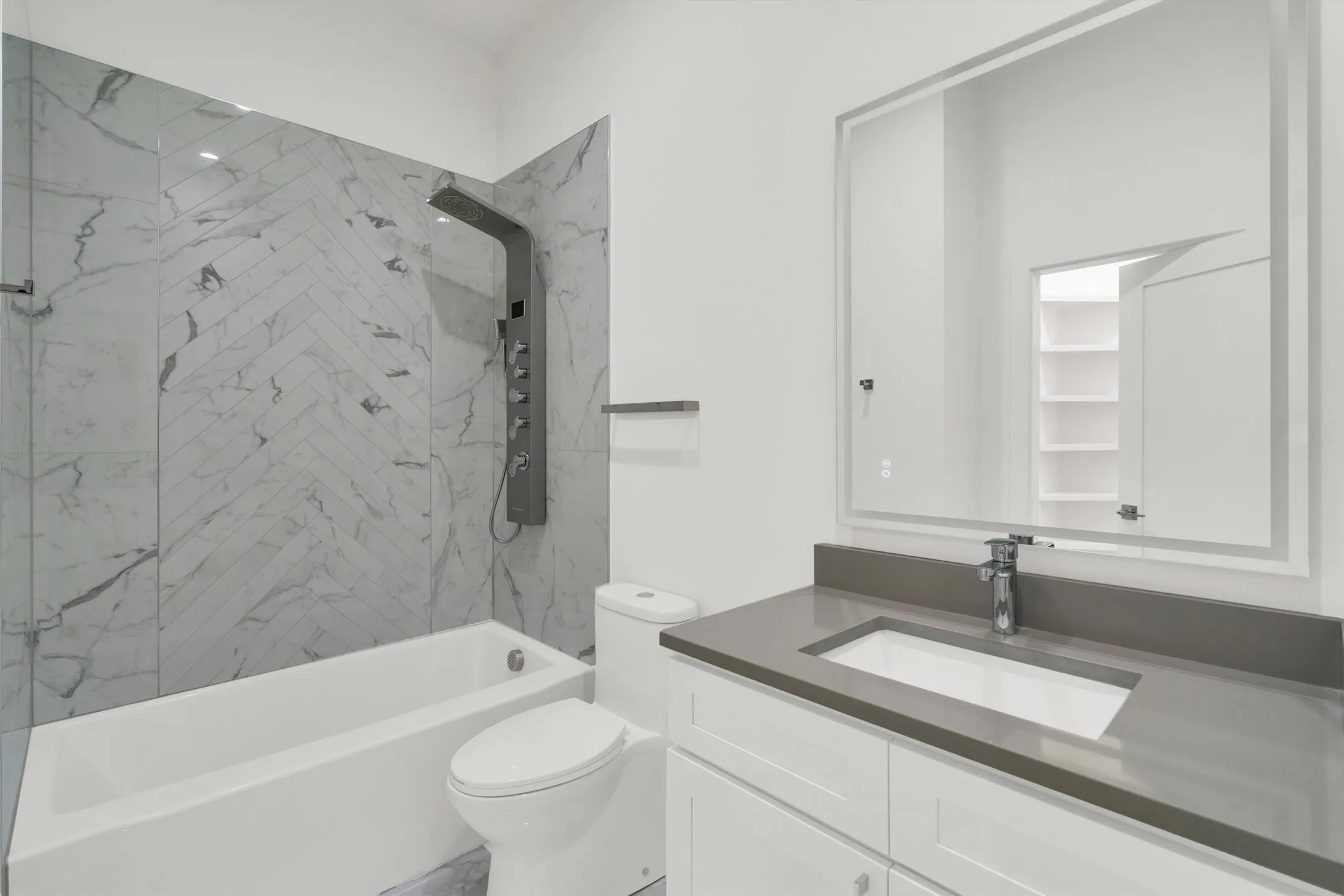 Full bath featuring toilet, vanity, and washtub / shower combination
