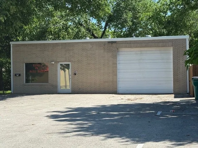 View of front of home featuring brick siding and a garage