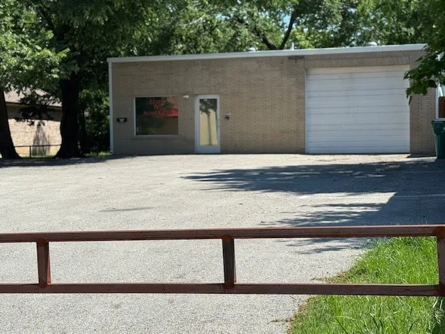 View of front of house featuring brick siding and an attached garage