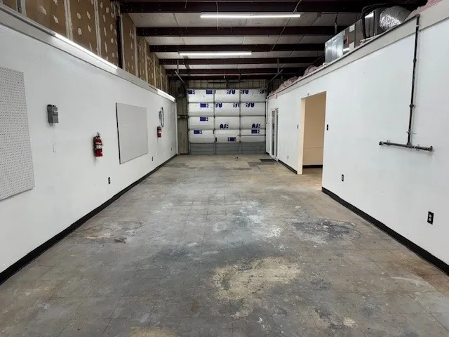 Garage featuring baseboards