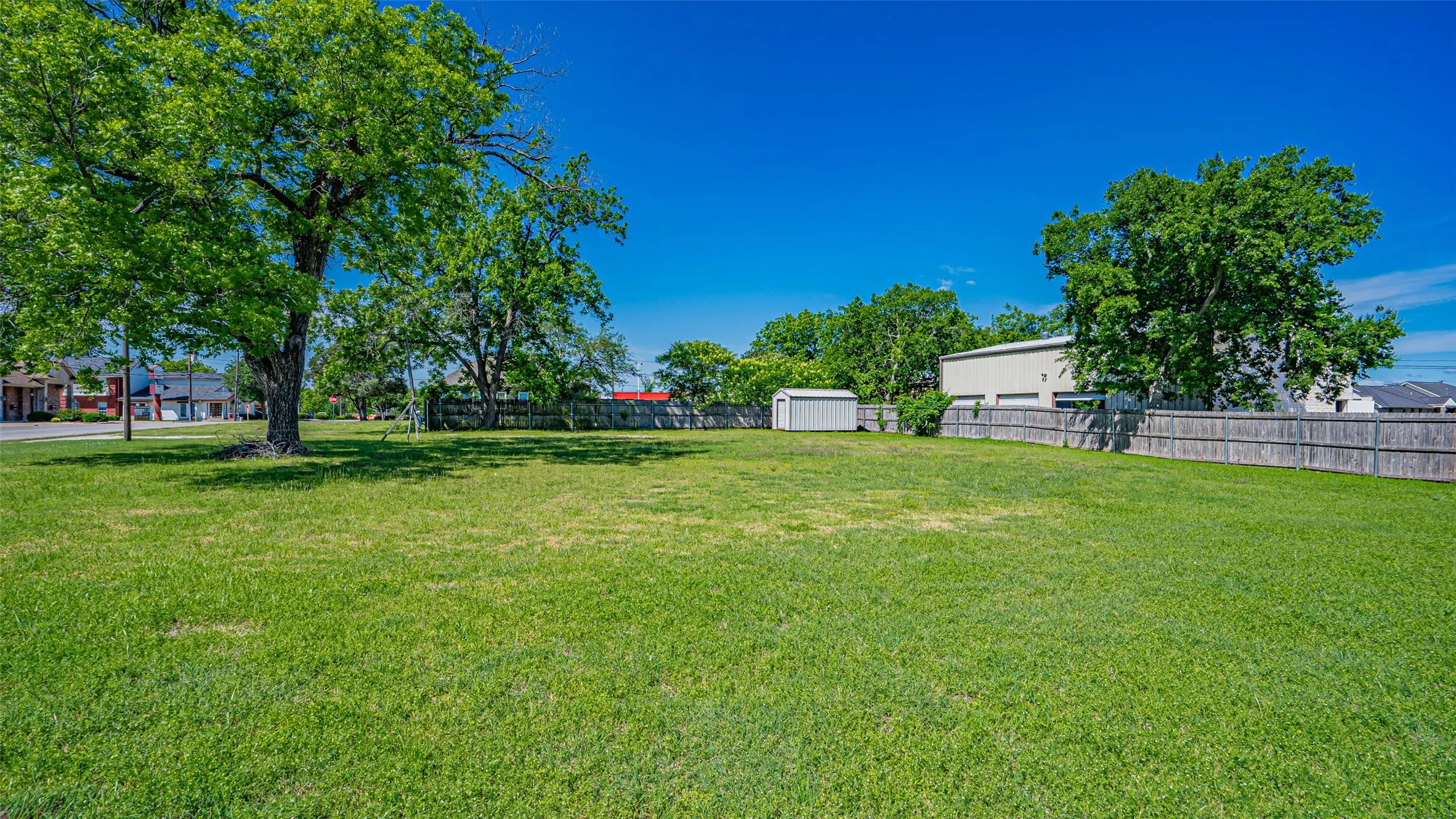 View of yard with a storage shed and an outbuilding