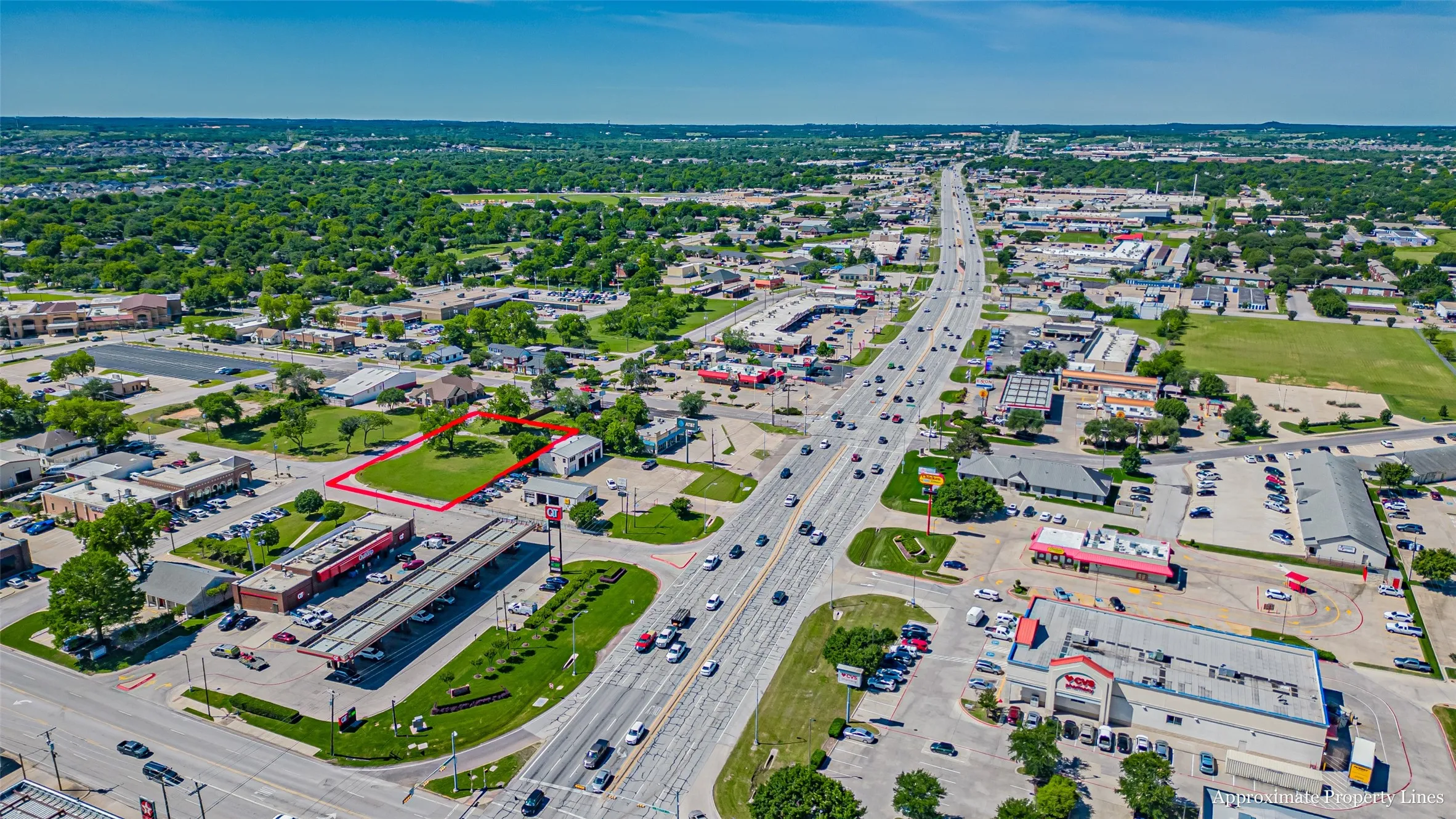 Aerial overview of property's location featuring a main thoroughfare and property boundaries highlighted