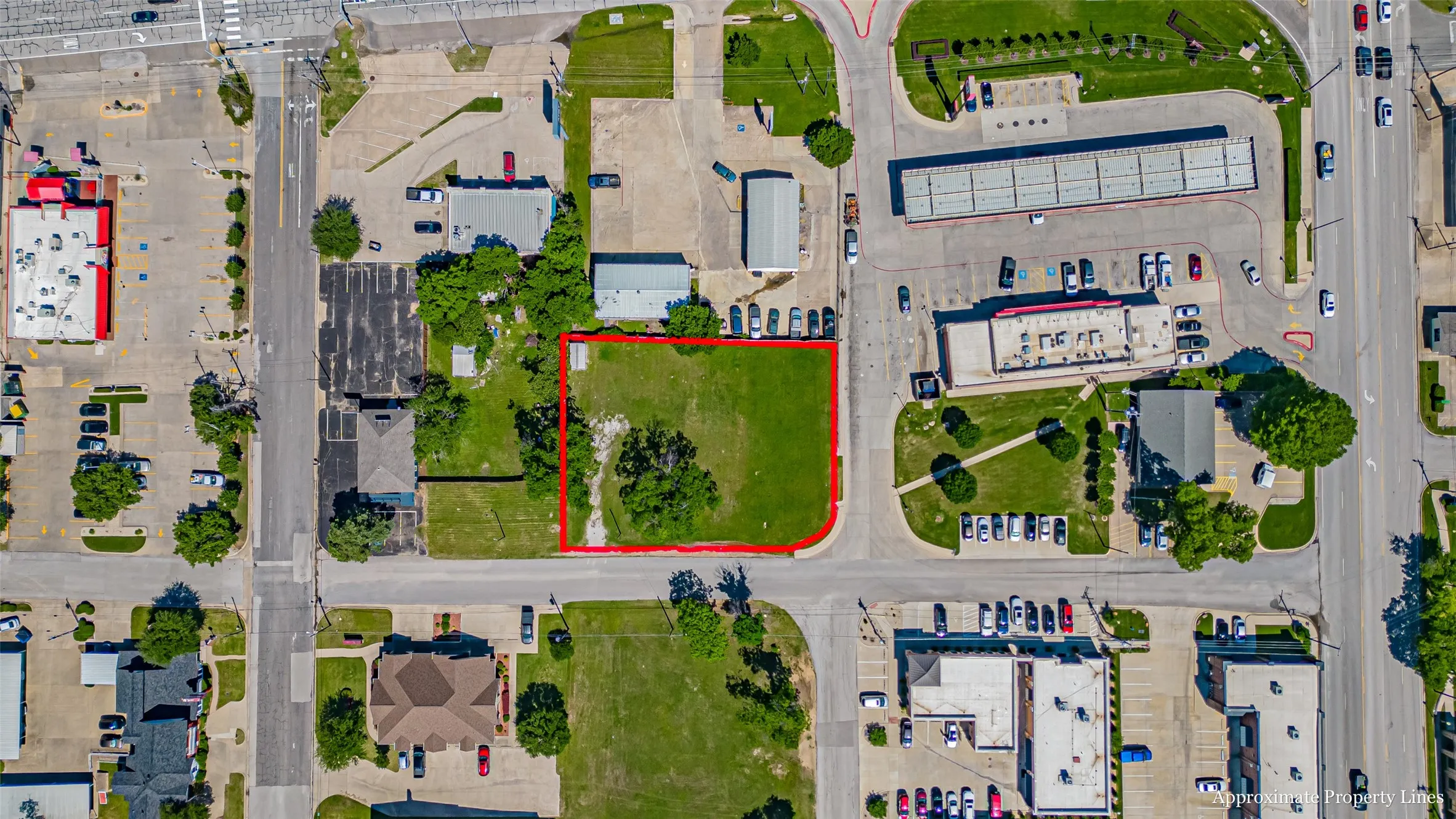 Aerial view of property and surrounding area with property parcel outlined