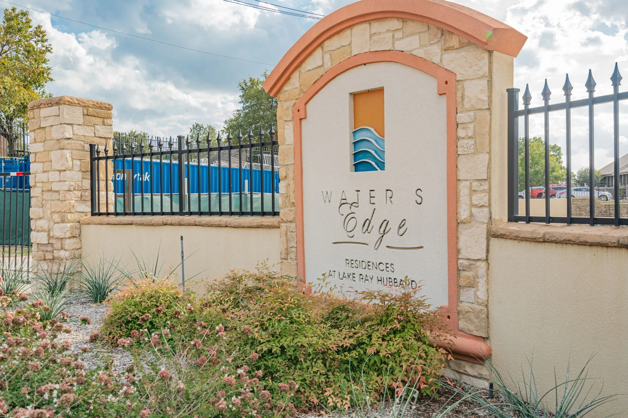 Community sign featuring fence
