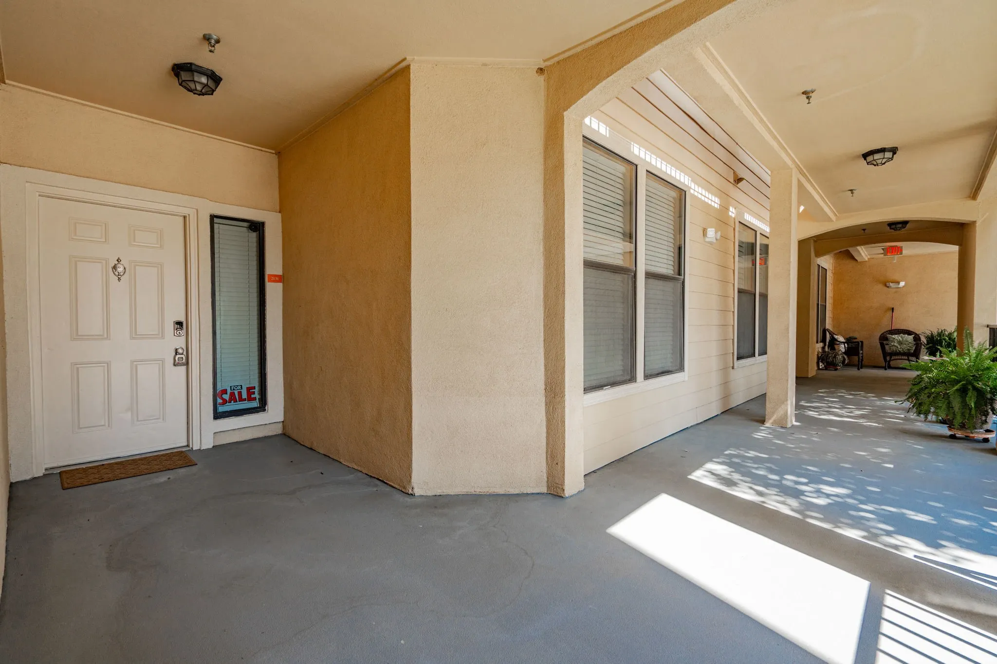 Entrance to property featuring a patio and stucco siding