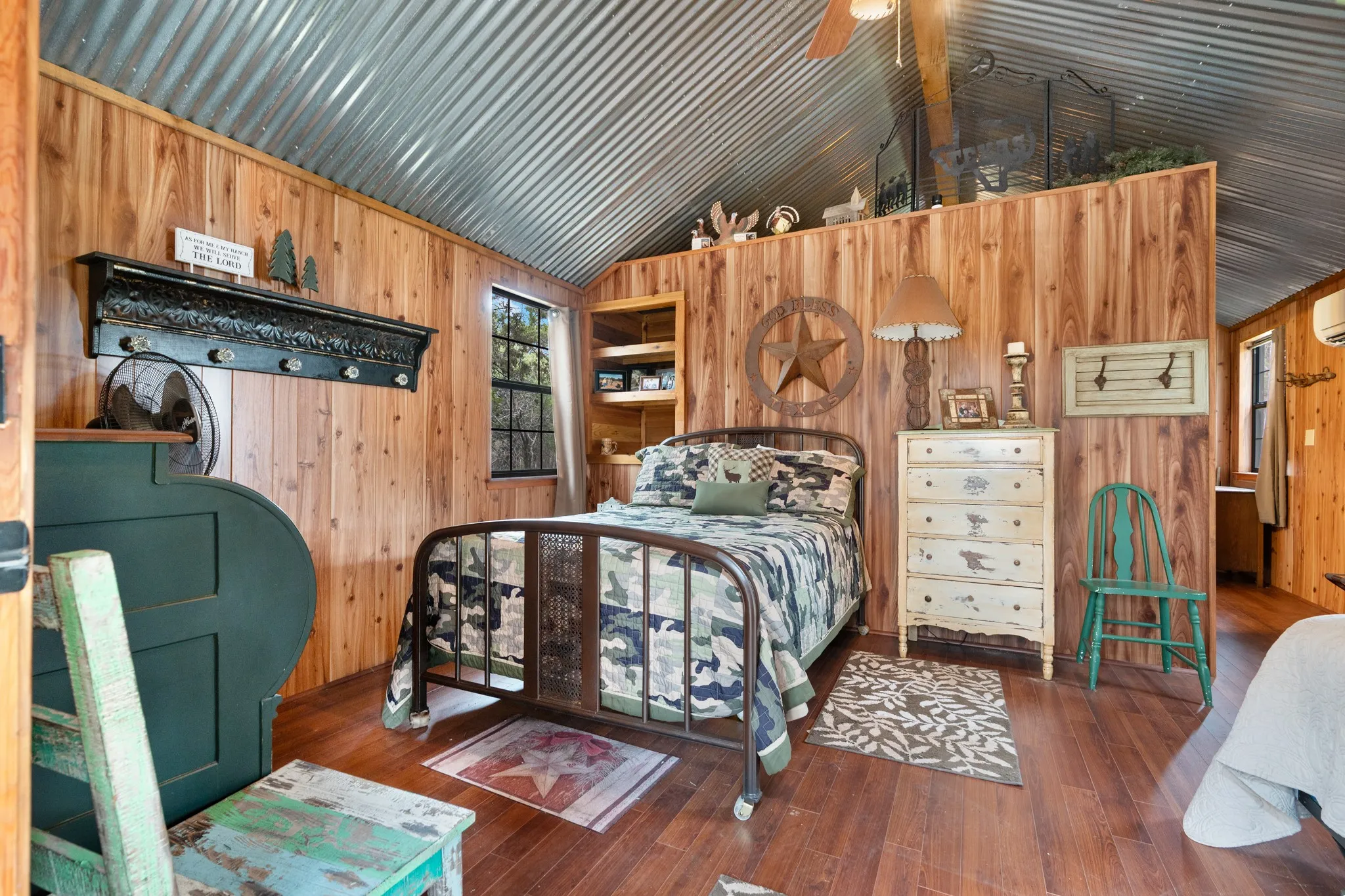 Bedroom with wood walls, lofted ceiling, and hardwood / wood-style floors