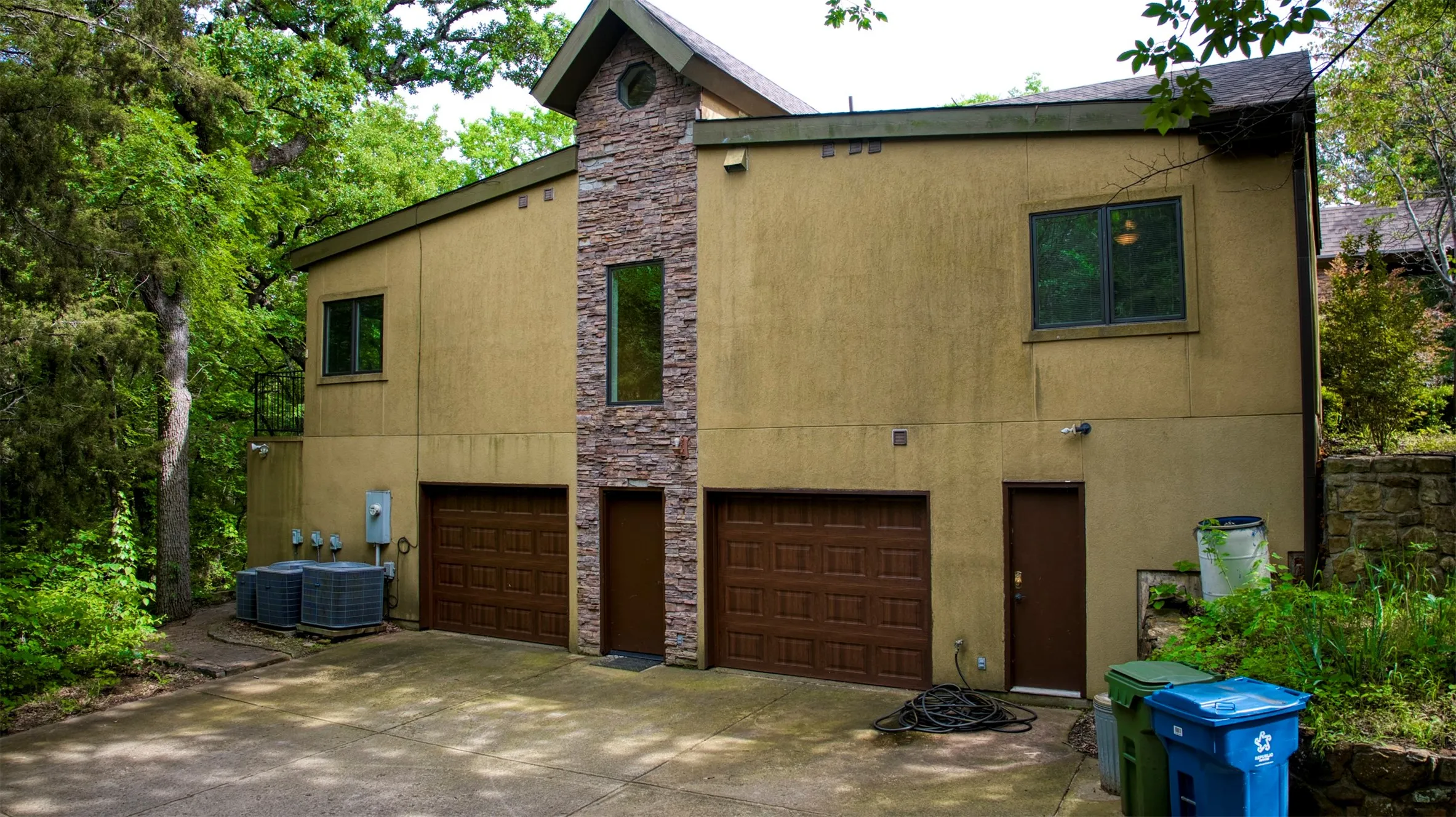 Side of property with garage entry.
