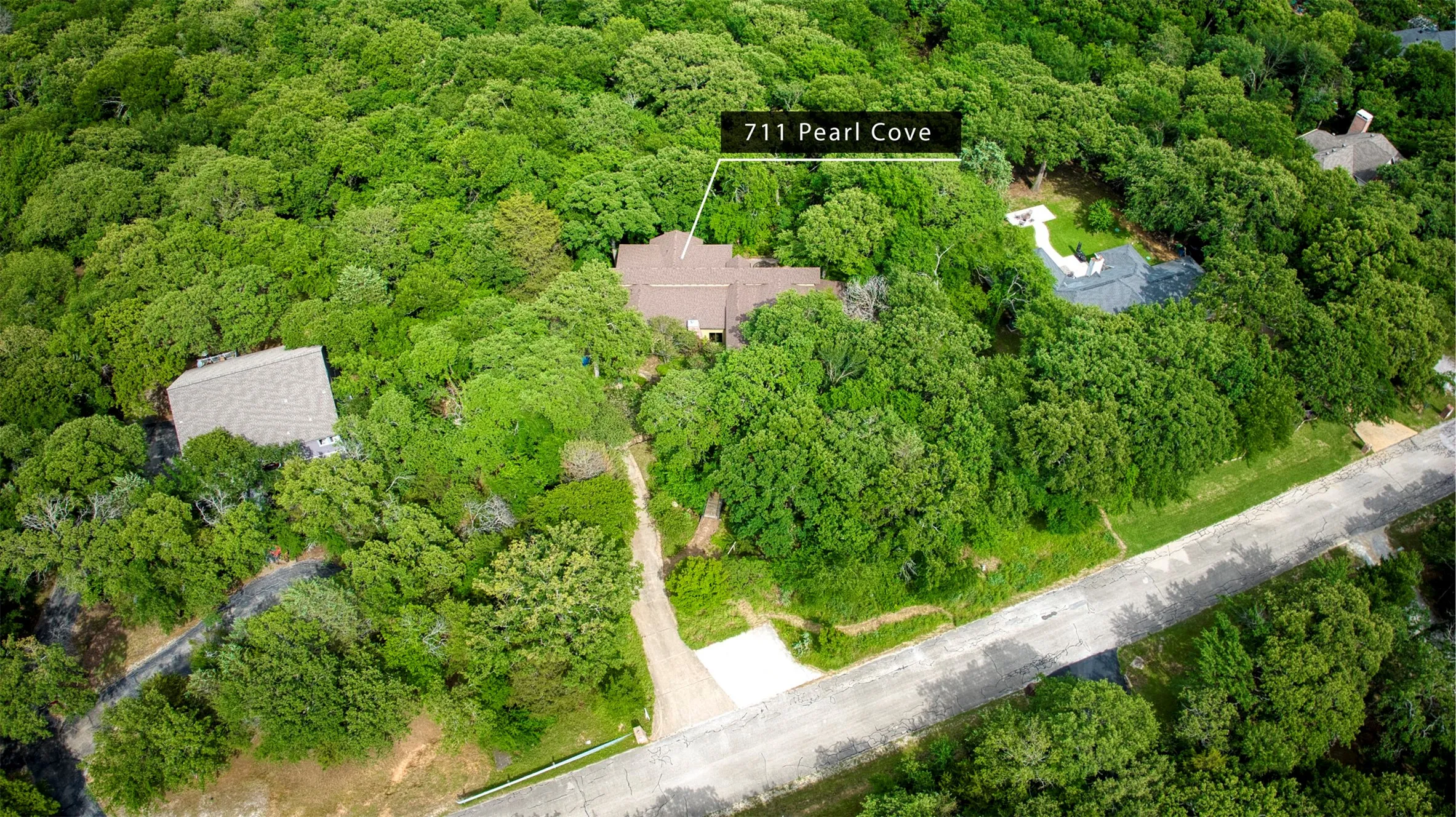 Aerial view of property and surrounding area featuring green space.